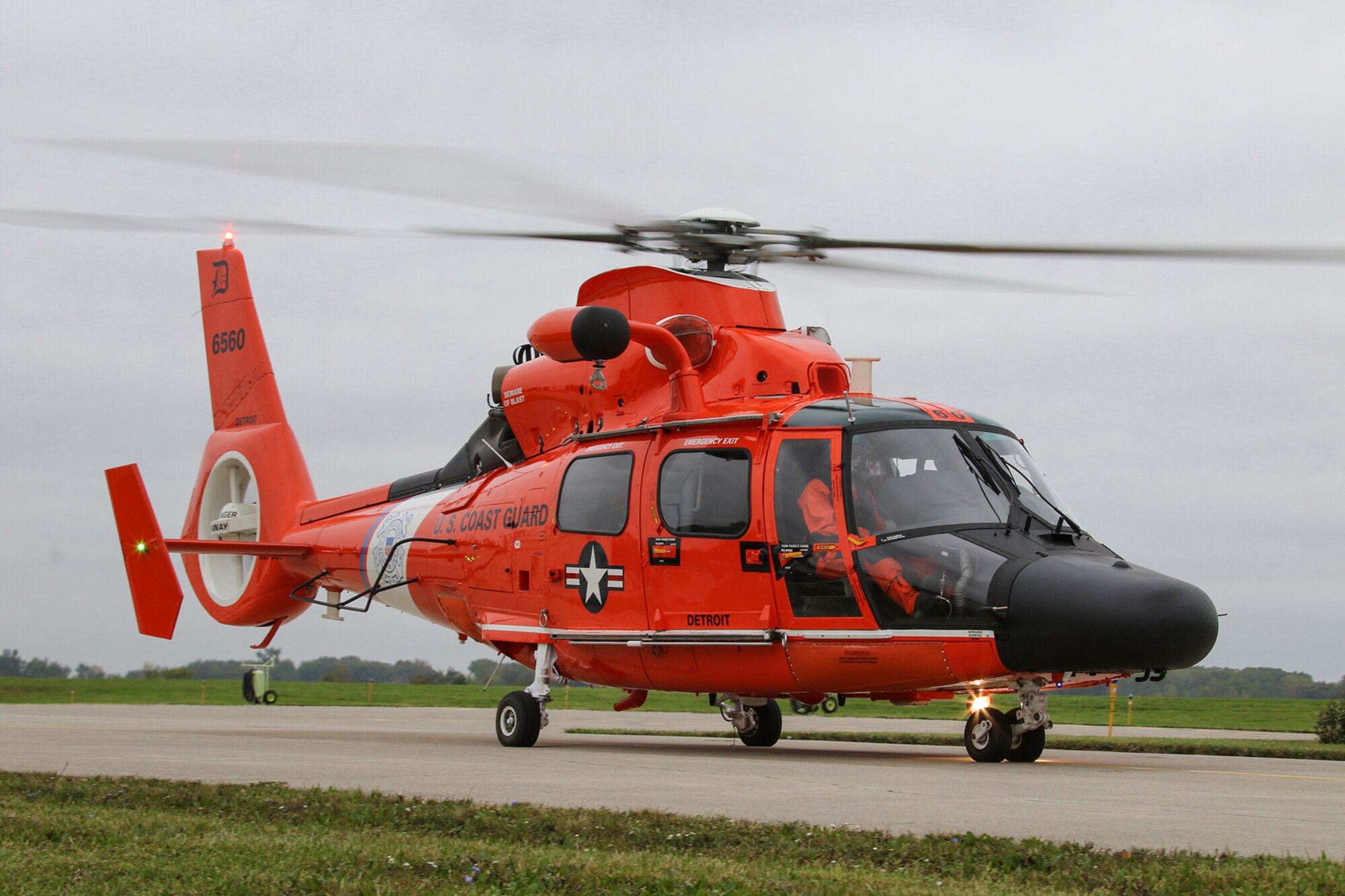 Orange helicopter on runway