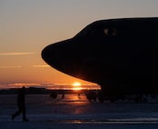 The sun rises behind a B-52H Stratofortress at Minot Air Force Base, North Dakota, Nov. 28, 2023. The B-52H can carry a payload of up to 70,000 pounds. (U.S. Air Force photo by Airman 1st Class Alyssa Bankston)