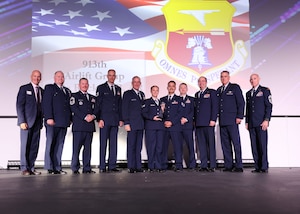 People pose for a photo on the stage.