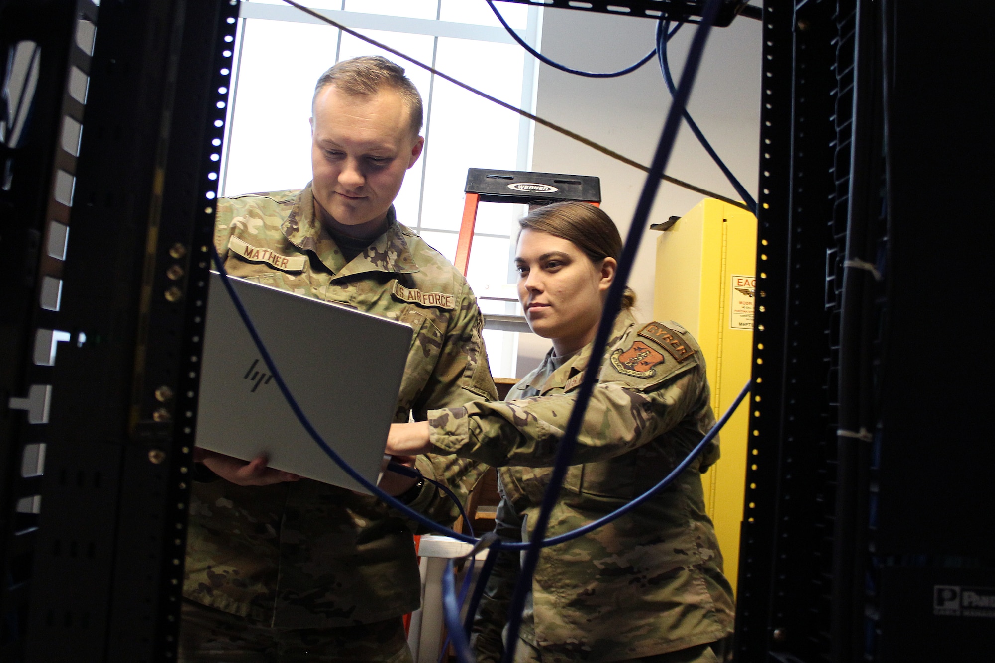 Senior Airmen Brock Mather and Alyssa Cross, both network systems operations specialist with the 127th Communications Flight, 127th Wing, work in a switch room at Selfridge Air National Guard Base, Michigan, Oct. 14, 2023.