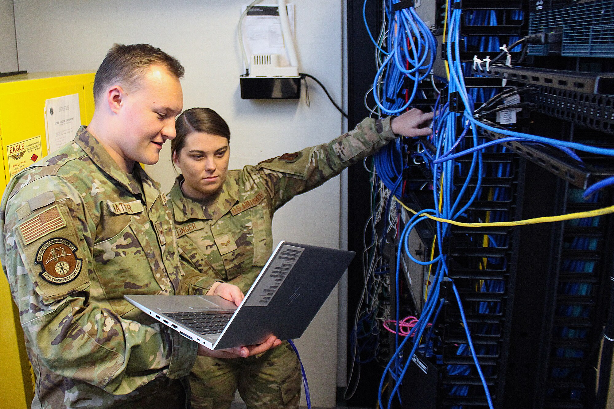 Senior Airmen Brock Mather and Alyssa Cross, both network systems operations specialist with the 127th Communications Flight, 127th Wing, work in a switch room at Selfridge Air National Guard Base, Michigan, Oct. 14, 2023.