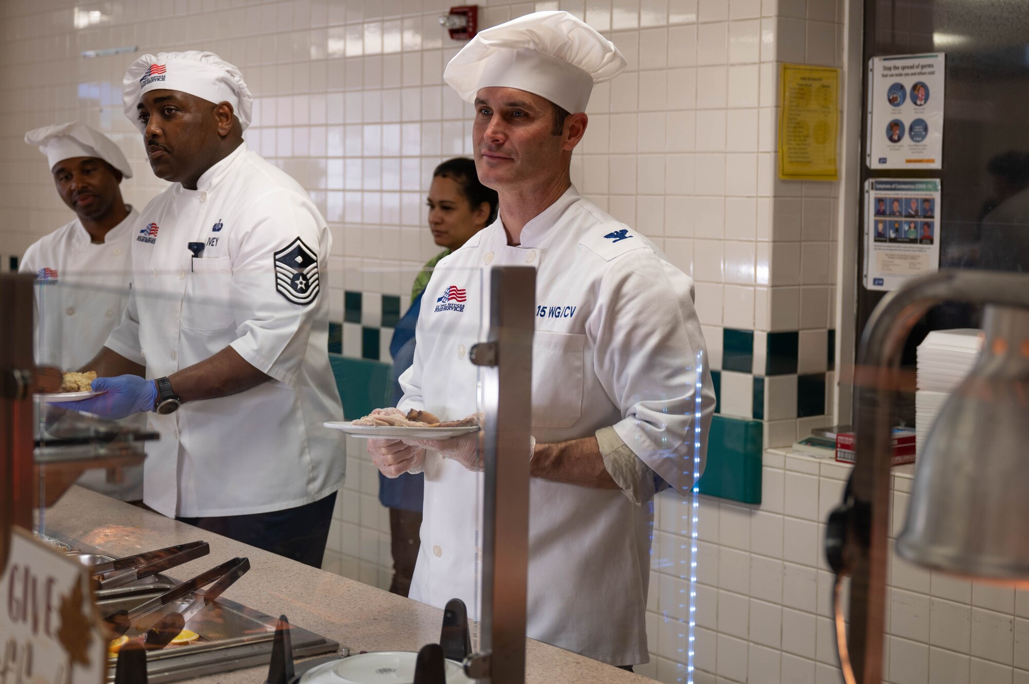 Col. Keith Young, 15th Wing deputy commander, serves Airmen lunch at Joint Base Pearl Harbor-Hickam, November 23, 2023. Leaders from the 15th Wing showed their appreciation to Airmen and their families by serving them lunch on Thanksgiving. (U.S. Air Force photo by 2nd Lieutenant Margaret Blice)