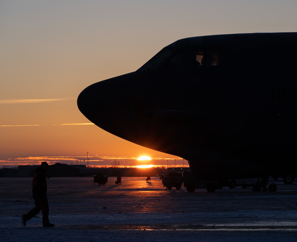 The sun rises behind a B-52H Stratofortress at Minot Air Force Base, North Dakota, Nov. 28, 2023. The B-52H can carry a payload of up to 70,000 pounds. (U.S. Air Force photo by Airman 1st Class Alyssa Bankston)