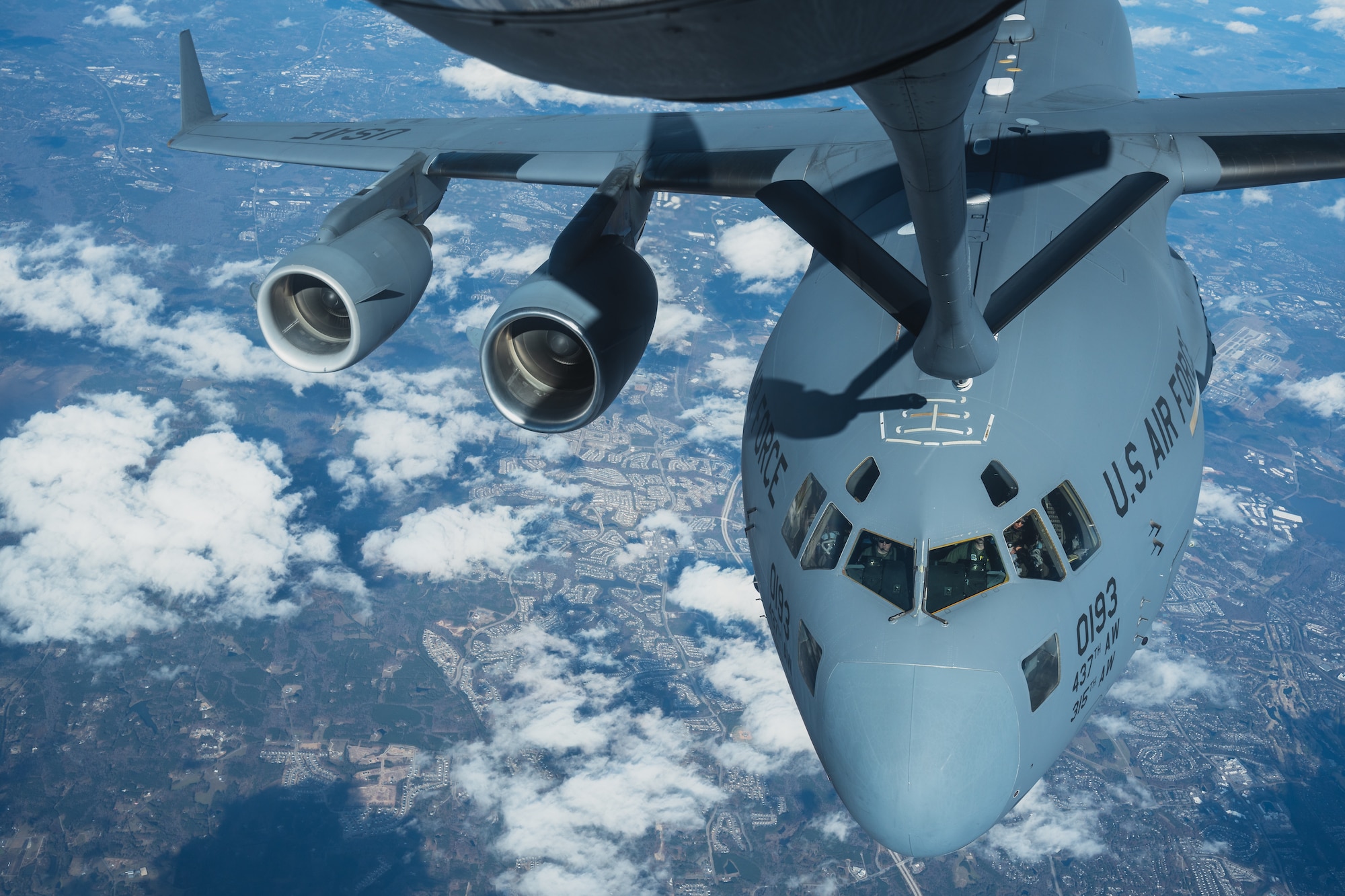 A KC-135 Stratotanker assigned to the 63rd Air Refueling Squadron, MacDill Air Force Base, Florida, refuels a C-17 Globemaster III assigned to the 15th Airlift Squadron, Joint Base Charleston, South Carolina, over the Southeastern United States, Nov. 28, 2023.