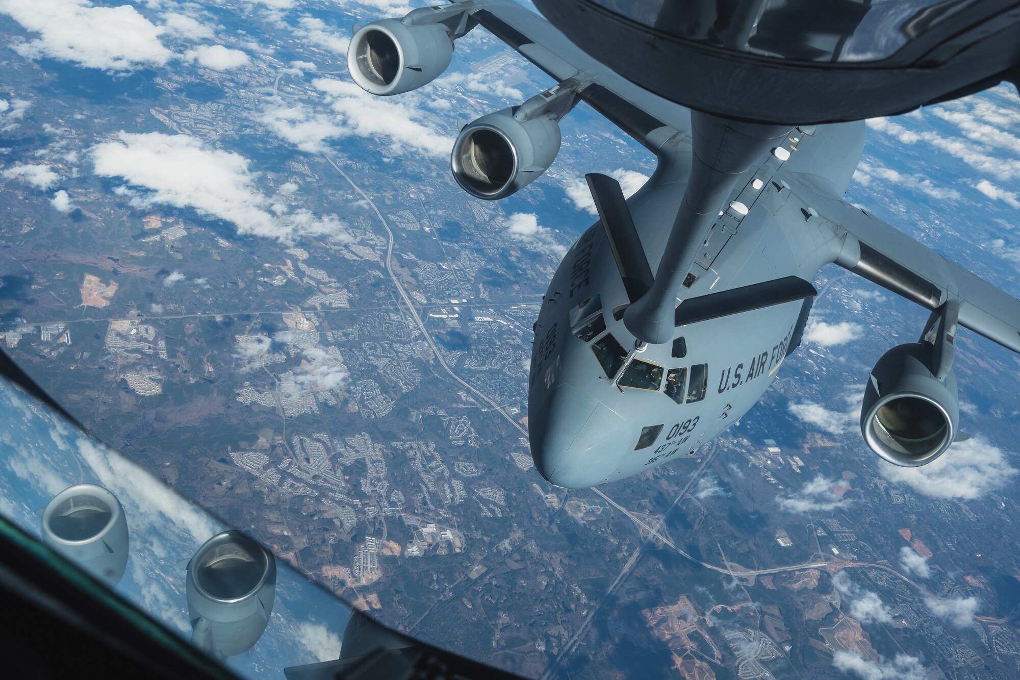 A KC-135 Stratotanker assigned to the 63rd Air Refueling Squadron, MacDill Air Force Base, Florida, refuels a C-17 Globemaster III assigned to the 15th Airlift Squadron, Joint Base Charleston, South Carolina, over the Southeastern United States, Nov. 28, 2023.