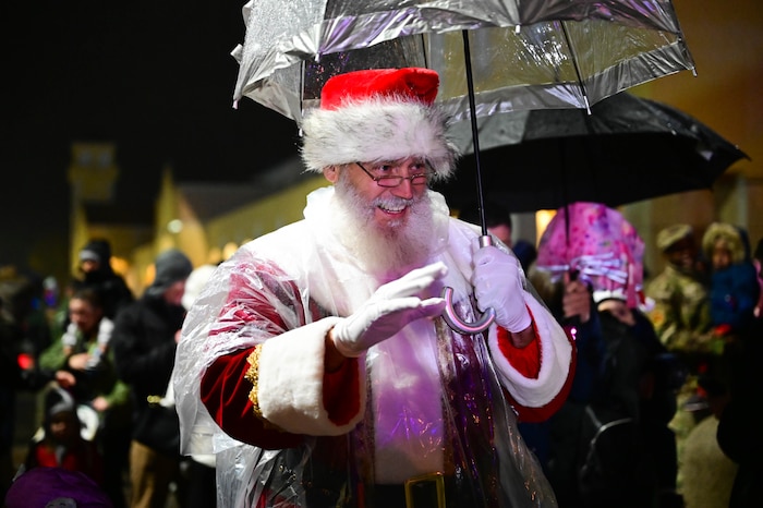 Santa Claus waves to the crowd as he arrives on base during the annual Wyvern Wonderland.