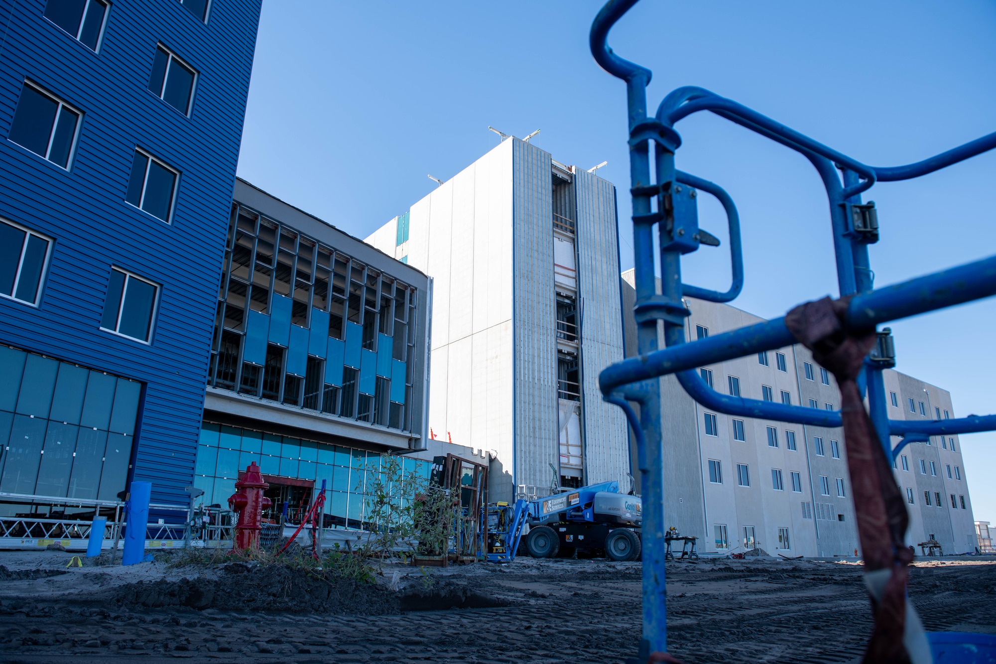 Five story building is pictured on a construction site.