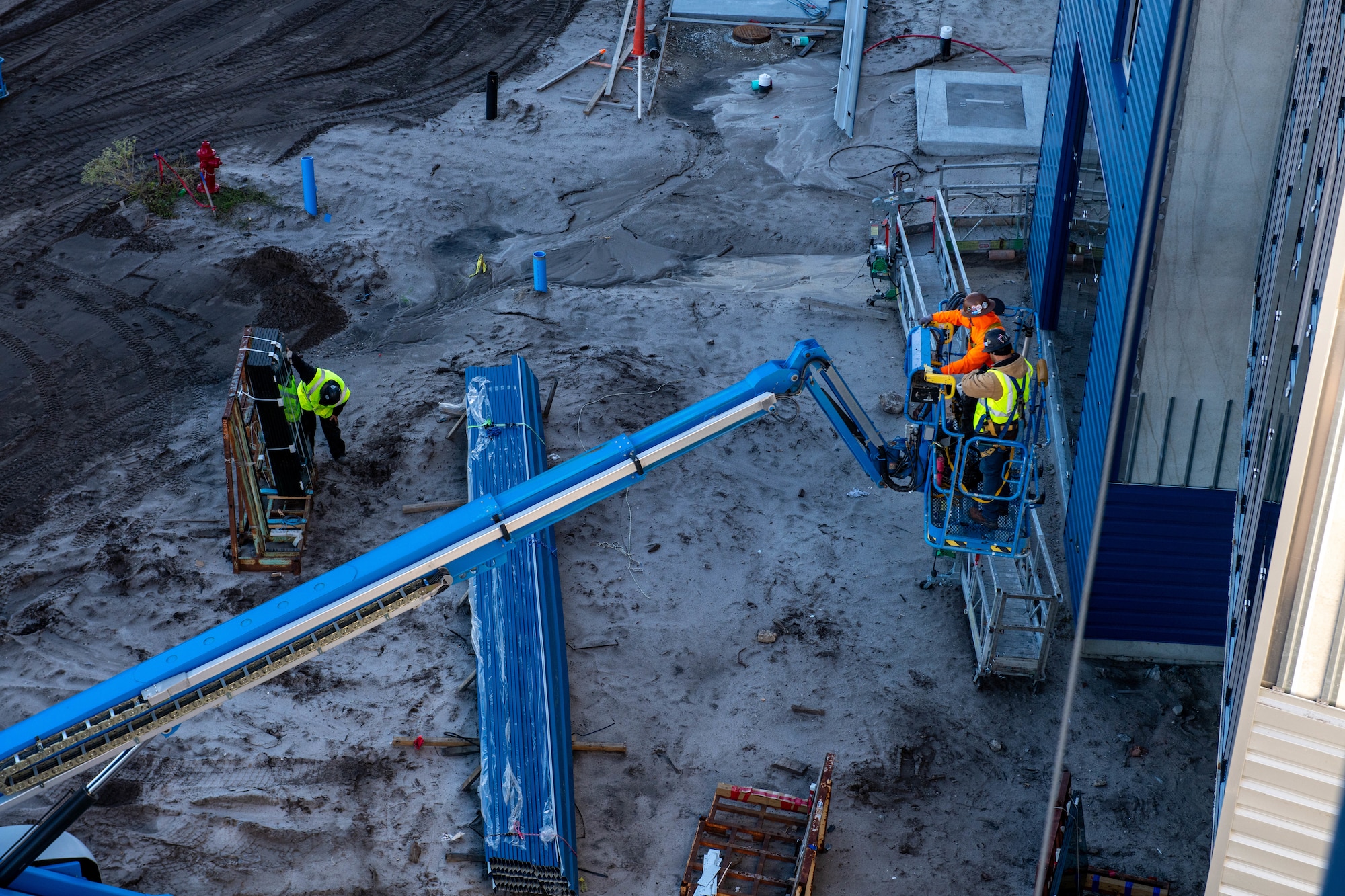 Construction crews use a lift while working on the new Sand Dollar Inn lodging facility