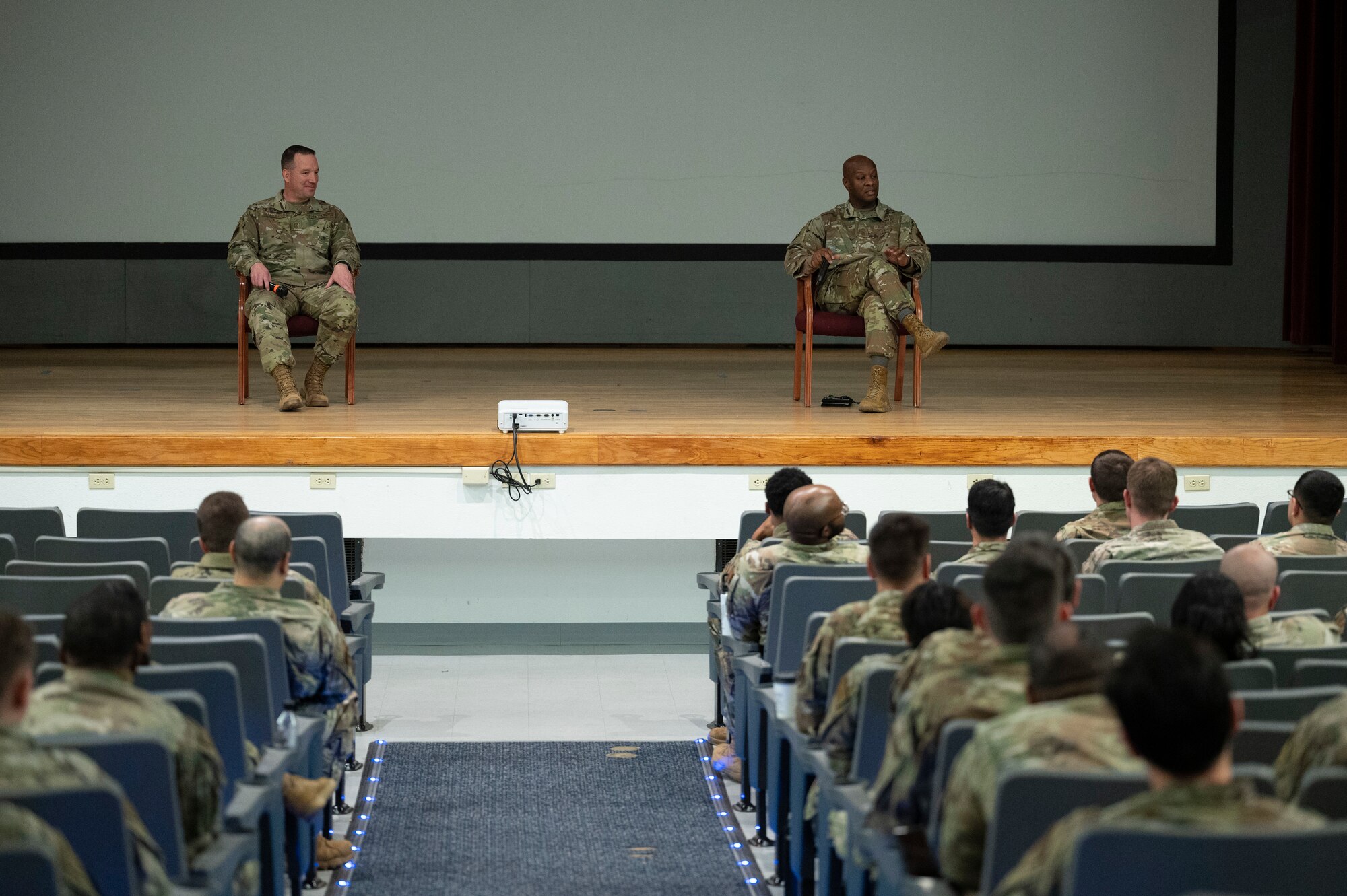 A group of people listen to a briefing.
