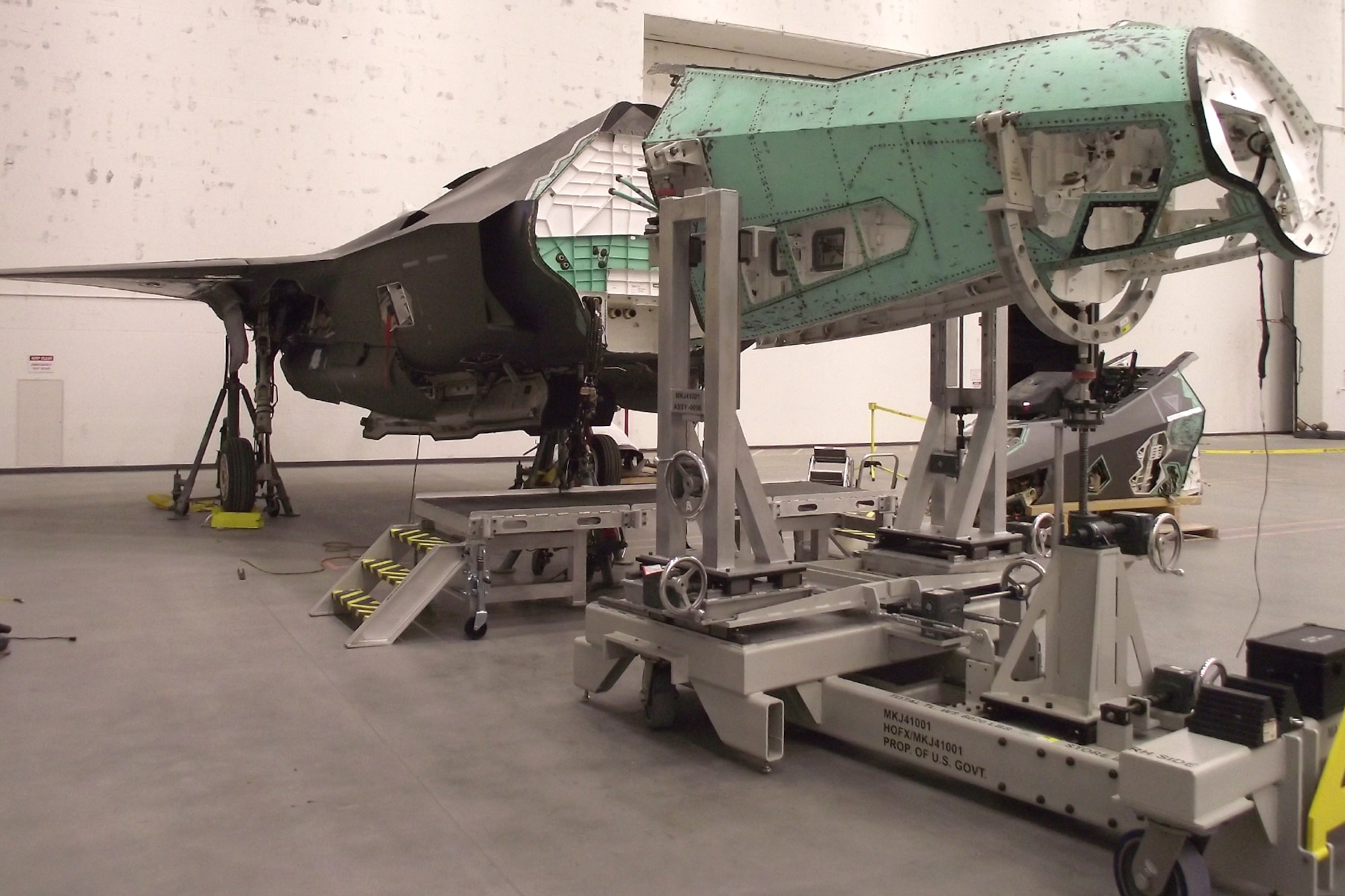 A new Mobil Maintenance System supports the donated nose section from a salvaged F-35 airframe used as an Aircraft Battle Damage Repair trainer at Hill Air Force Base, Utah, in October 2023. The MMS was created to de-mate and re-mate aircraft sections during a total reconstruction project of a wrecked F-35A Lightning II by the F-35 Joint Program Office. The project aims to restore the aircraft to full operational flying status. (U.S Air Force courtesy photo)