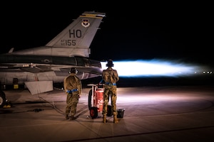 Airmen from the 311th Aircraft Maintenance Unit conduct an F-16 Viper high-power engine run afterburner maintenance at Holloman Air Force Base, New Mexico, Nov. 16, 2023. Afterburner operation occurs when raw jet fuel is injected into the engine augmenter, resulting in a long cone of fire out of the exhaust and generating twenty-four thousand pounds of thrust propelling the airframe. (U.S. Air Force photo by U.S. Air Force Airman 1st Class Michelle Ferrari)