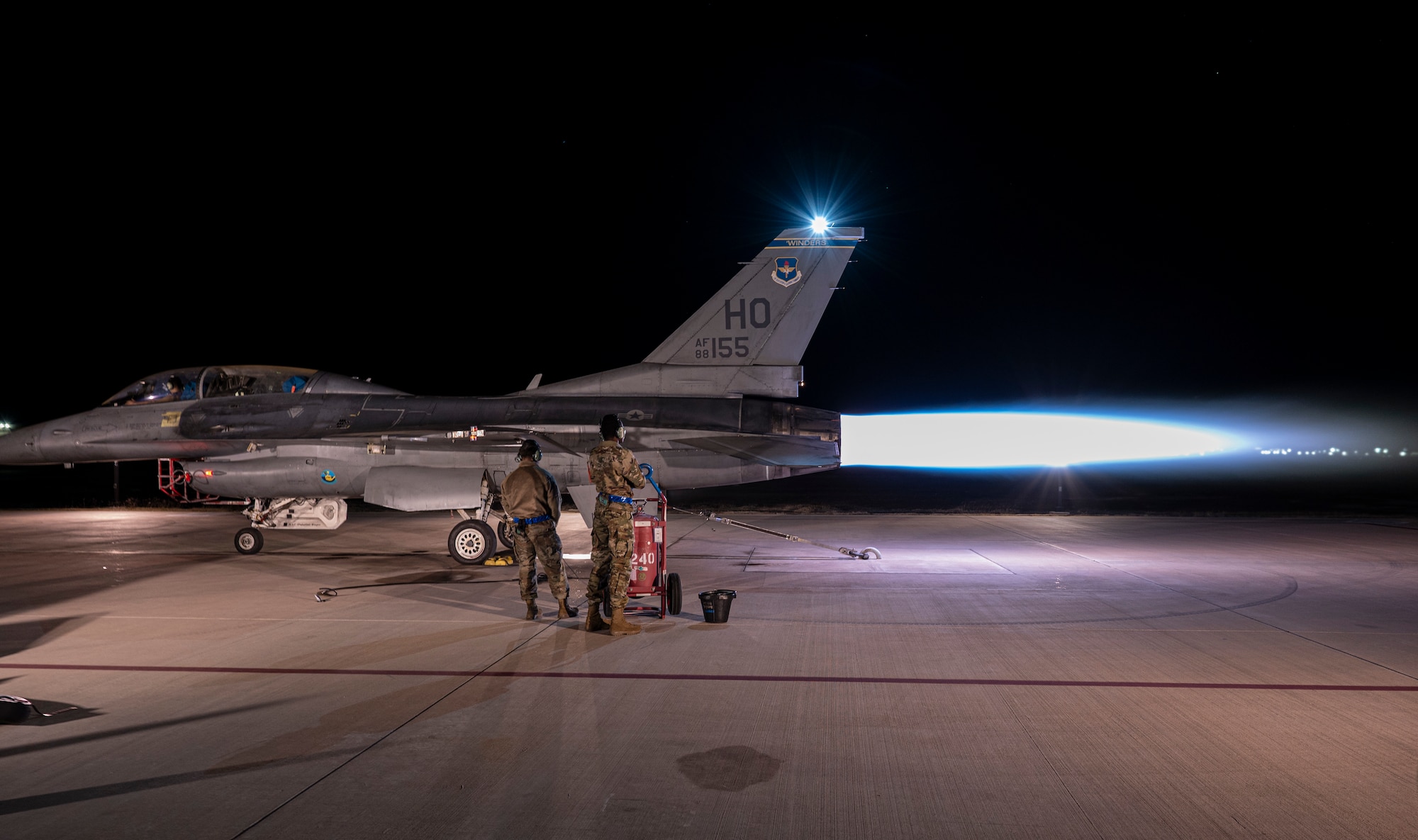 Airmen from the 311th Aircraft Maintenance Unit conduct an F-16 Viper high-power engine run afterburner at Holloman Air Force Base, New Mexico, Nov. 16, 2023. Afterburner operation occurs when raw jet fuel is injected into the engine augmenter, resulting in a long cone of fire out of the exhaust and generating twenty-four thousand pounds of thrust propelling the airframe. (U.S. Air Force photo by U.S. Air Force Airman 1st Class Michelle Ferrari)