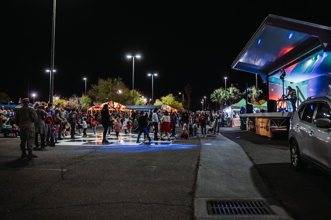 Service members, Department of Defense civilians, and families from Marine Corps Air-Ground Combat Center dance during the annual Christmas Tree Lighting Ceremony at MCAGCC, Twentynine Palms, California, Nov. 17, 2023. The tree lighting ceremony is an annual event to kick off the holiday season with music, food, and fun to enhance the quality of life for the service members and DoD civilians of The Combat Center. (U.S. Marine Corps photo by Lance Cpl. Richard PerezGarcia)