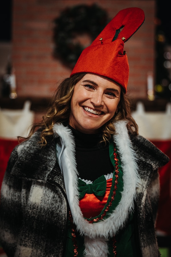 Erika Leet, a marketing employee with Marine Corps Community Services Twentynine Palms, poses for a photo during the annual Christmas Tree Lighting Ceremony at Marine Corps Air-Ground Combat Center, Twentynine Palms, California, Nov. 17, 2023. The tree lighting ceremony is an annual event to kick off the holiday season with music, food, and fun to enhance the quality of life for the service members and DoD civilians of The Combat Center. (U.S. Marine Corps photo by Lance Cpl. Richard PerezGarcia)