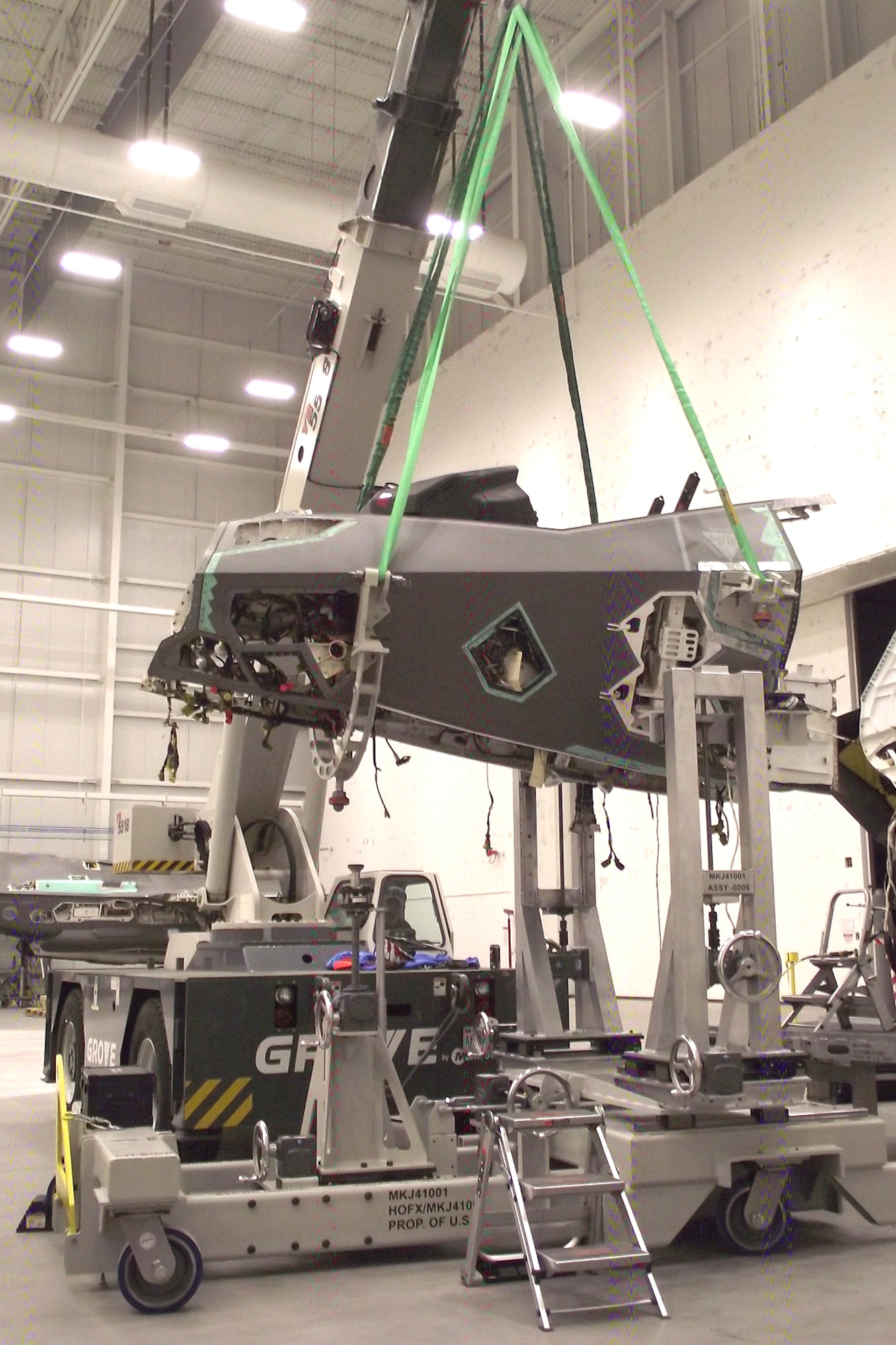 A damaged nose section is removed from an F-35 airframe using a new Mobil Maintenance System at Hill Air Force Base, Utah, in October 2023. The MMS was created to de-mate and re-mate aircraft sections during a total reconstruction project of a wrecked F-35A Lightning II by the F-35 Joint Program Office. The project aims to restore the aircraft to full operational flying status. (U.S Air Force courtesy photo)