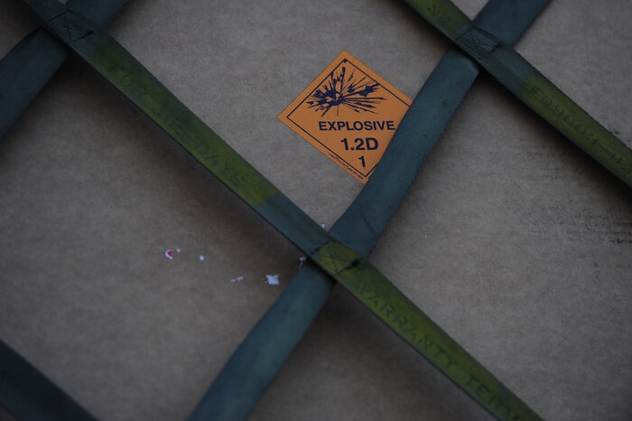 A container is marked with an orange Explosive 1.2D decal.