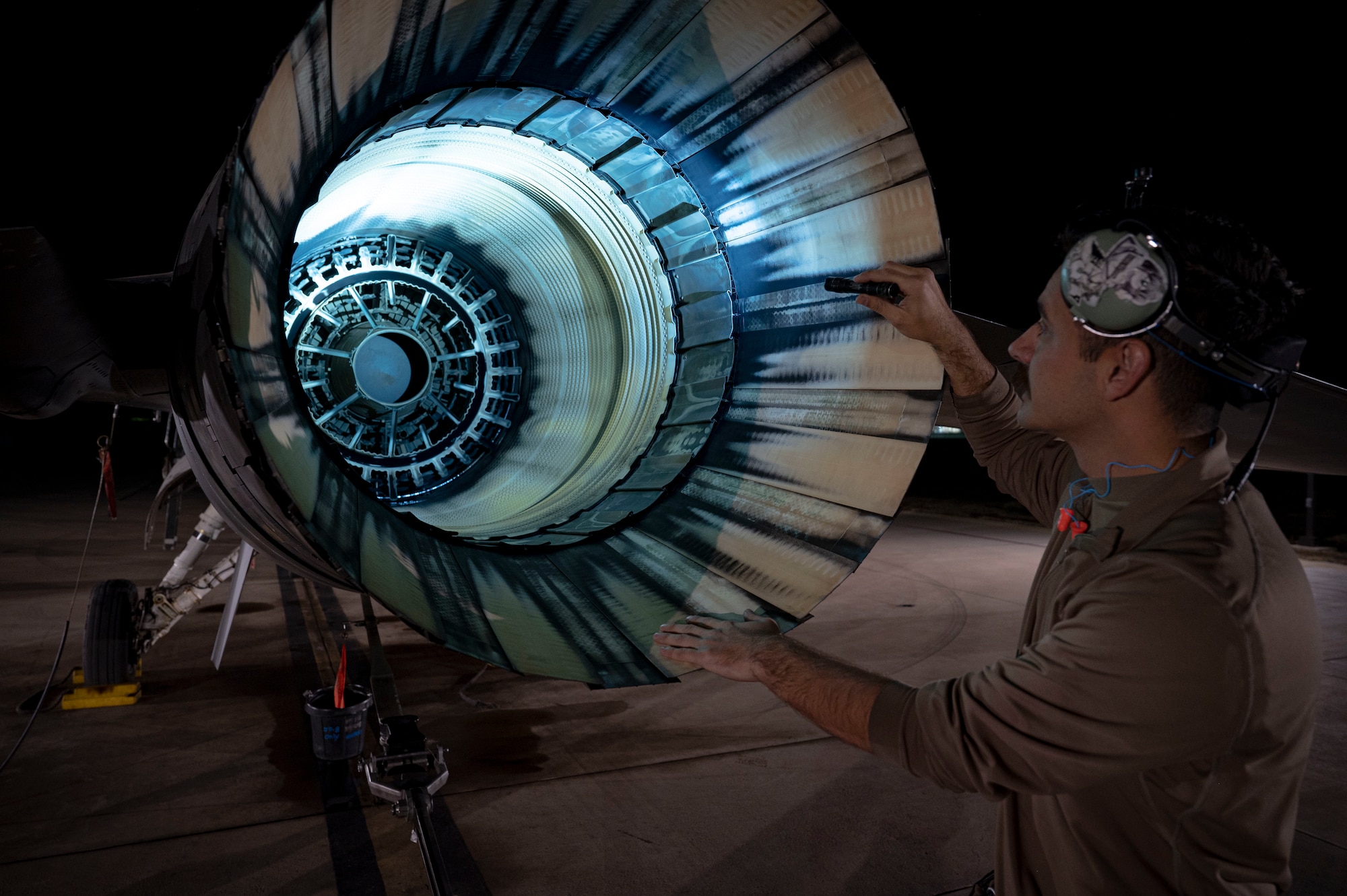 U.S. Air Force Staff Sgt. Nathan Nybakke, 311th Maintenance Squadron Propulsion non-commissioned officer in charge, performs afterburner exhaustion inspection of an F-16 Viper at Holloman Air Force Base, New Mexico, Nov. 16. 2023. High-power engine run maintenance involves verification of serviceability of the aircraft and engine prior to and after flight or maintenance completion. (U.S. Air Force photo by U.S. Air Force Airman 1st Class Michelle Ferrari)