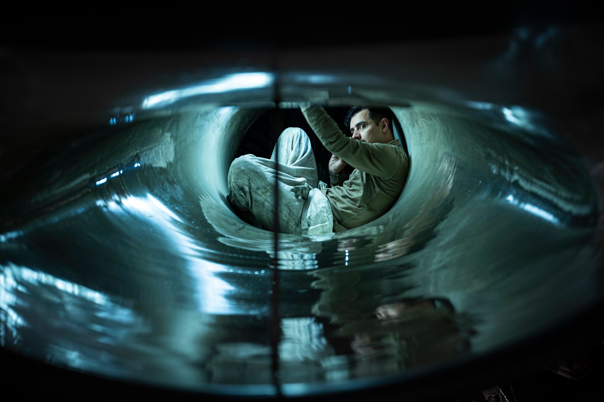 U.S. Air Force Staff Sgt. Nathan Nybakke, 311th Maintenance Squadron Propulsion non-commissioned officer in charge, performs intake inspection of F-16 Viper at Holloman Air Force Base, New Mexico, Nov. 16. 2023. High-power engine run maintenance involves verification of serviceability of the aircraft and engine prior to and after flight or maintenance completion. (U.S. Air Force photo by U.S. Air Force Airman 1st Class Michelle Ferrari)