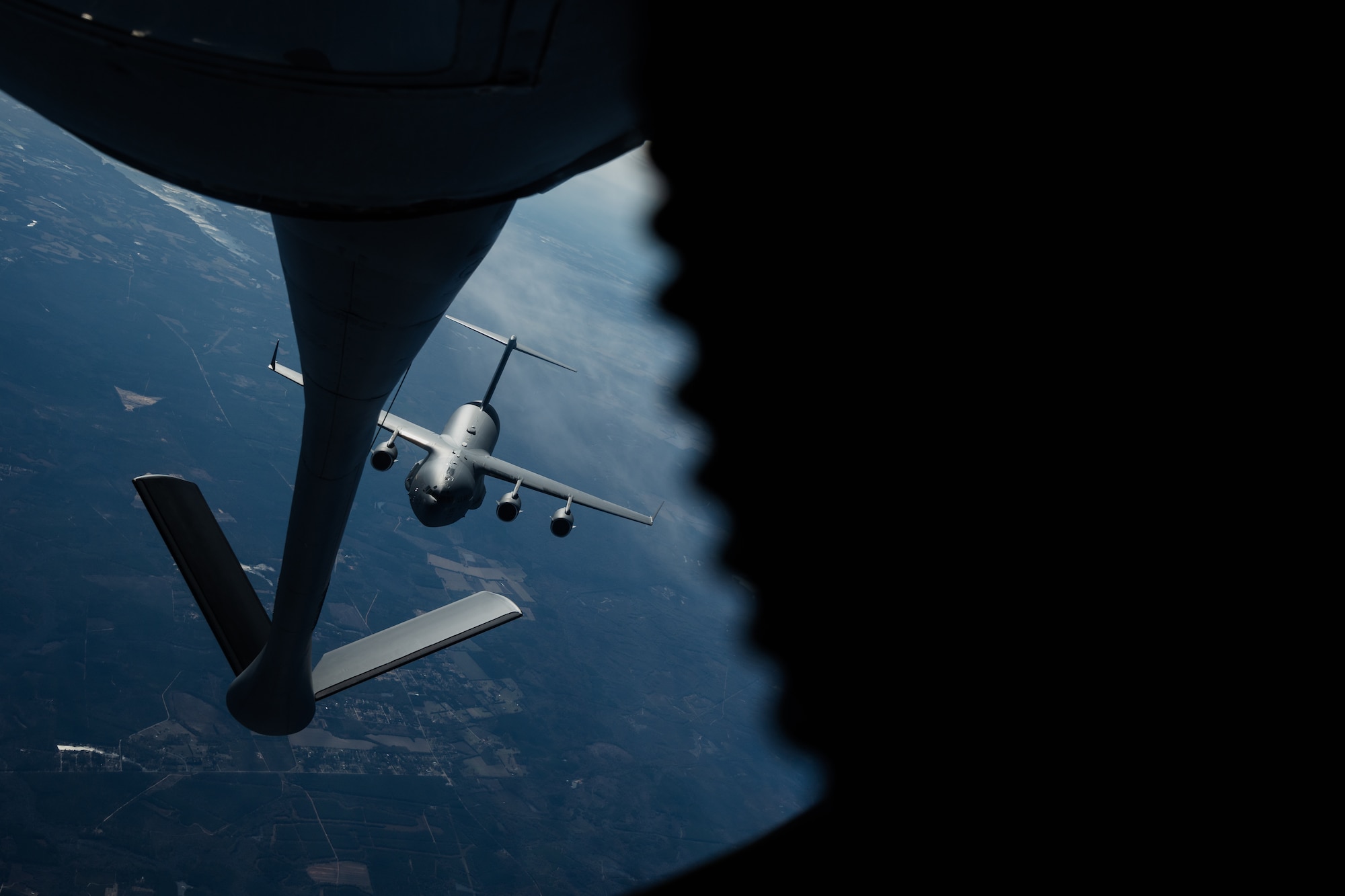 A C-17 Globemaster III assigned to the 15th Airlift Squadron, Joint Base Charleston, South Carolina, approaches a KC-135 Stratotanker assigned to the 63rd Air Refueling Squadron, MacDill Air Force Base, Florida, over the Southeastern United States, Nov. 28, 2023.