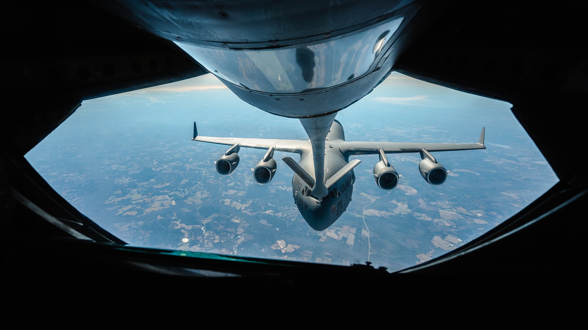 A KC-135 Stratotanker assigned to the 63rd Air Refueling Squadron, MacDill Air Force Base, Florida, refuels a C-17 Globemaster III assigned to the 15th Airlift Squadron, Joint Base Charleston, South Carolina, over the Southeastern United States, Nov. 28, 2023.