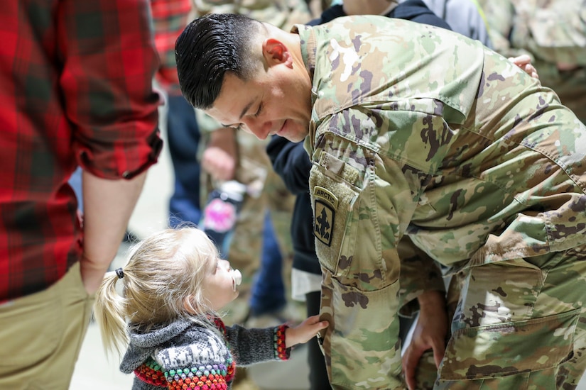 Alaska Army National Guard 1st Sgt. Oliver Meza, Bravo Company first sergeant, shows off his unit’s patch during a deployment ceremony where family members, friends, and fellow Guardsmen came together to pay tribute to Soldiers of B Co., 1st Battalion, 297th Infantry Regiment, at the Alaska National Guard Armory on Joint Base Elmendorf-Richardson, Sept. 29, 2023.