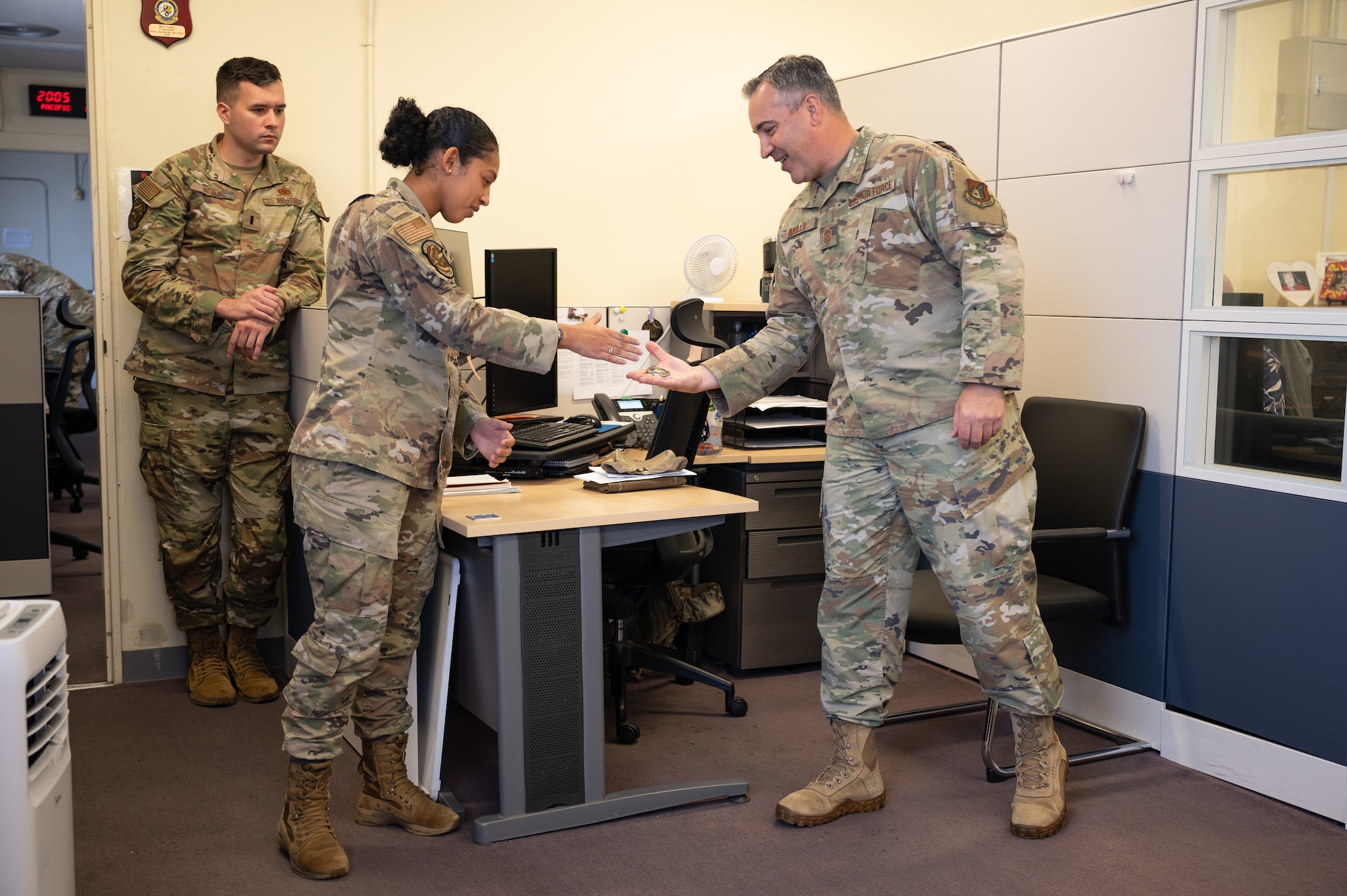 Two Airman shake hands.