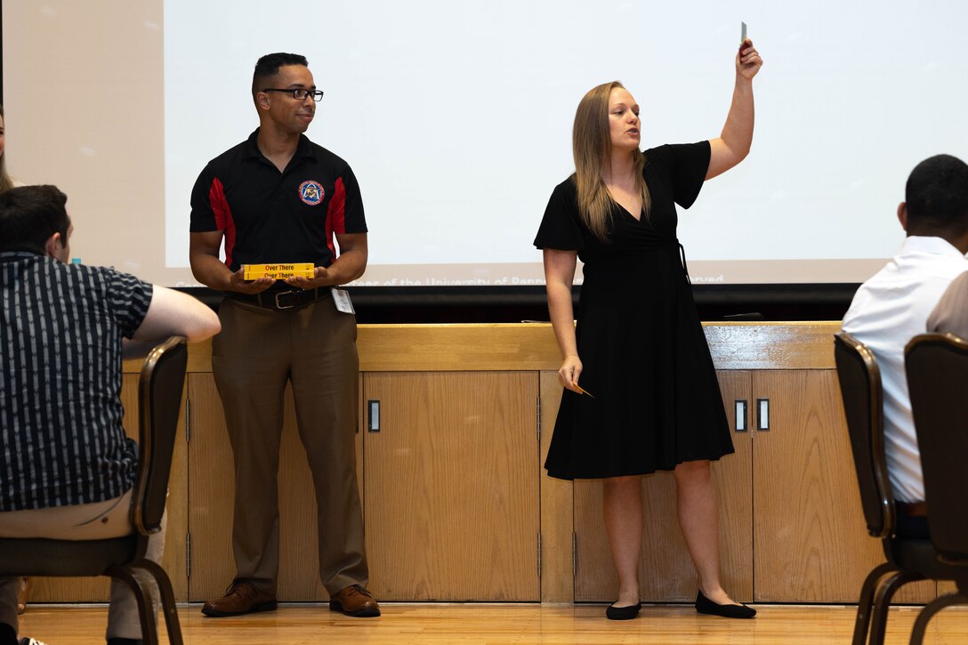 U.S. Marine Corps Staff Sgt. Patrick Schindlbeck, left, an inventory management specialist with Marine Aircraft Group 36, 1st Marine Aircraft Wing, and Lauren Swinson an Embedded Preventive Behavioral Health Capability Analyst, go over different perspectives involved in a case study at a Marine Corps Association Professional Leaders Seminar on Suicide Awareness and Prevention on Camp Hansen, Okinawa, Japan, Sept. 27, 2023. The seminar was held to discuss the topic of suicide, and to share suicide prevention resources with key leaders, specifically staff noncommissioned officers and noncommissioned officers. 

(U.S. Marine Corps photo by Cpl. Matthew Krogull)