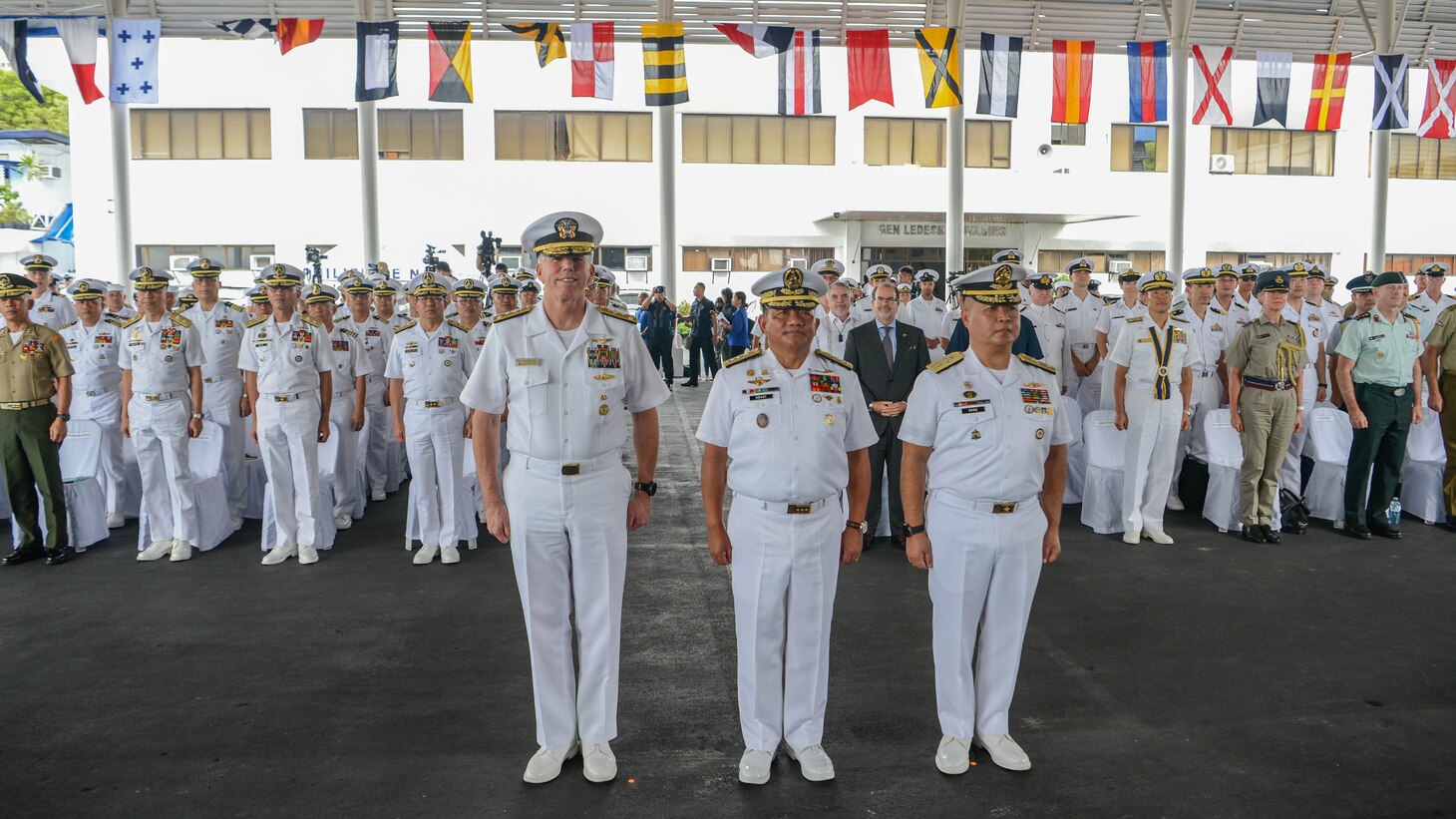 MANILA, Philippines (Oct. 2, 2023) – Vice Adm. Karl Thomas, Commander, Seventh Fleet, left, Vice Adm. Toribio D. Adaci Jr., Flag Officer in Command, Philippine Navy, center, and Commodore Joe Anthony C. Orbe, Commander, Naval Forces Southern Luzon, pose for a photo with service members of participating nations of Sama Sama 2023. MTA Sama Sama is a multilateral exercise including forces from Philippines, the United States, Australia, France, Japan, Canada and the United Kingdom designed to promote regional security cooperation, enhance maritime interoperability, and maintain and strengthen maritime partnerships. (U.S. Navy photo by Mass Communication Specialist Sean Lynch)