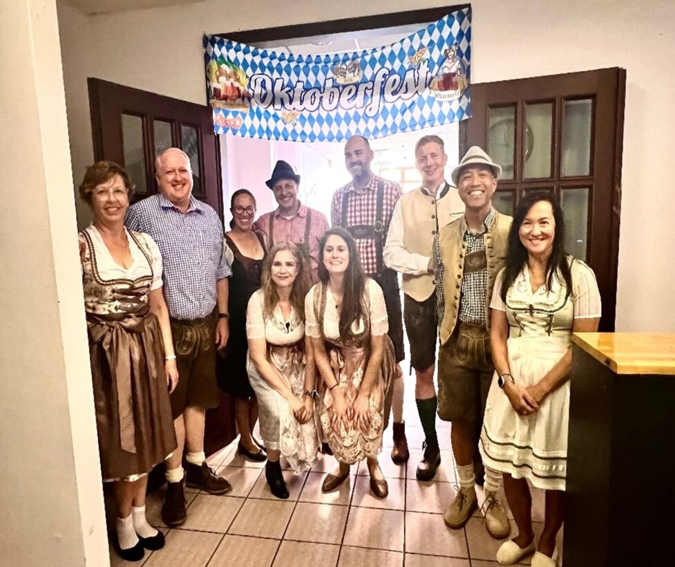 Group of people dressed in German Oktoberfest traditional clothing.