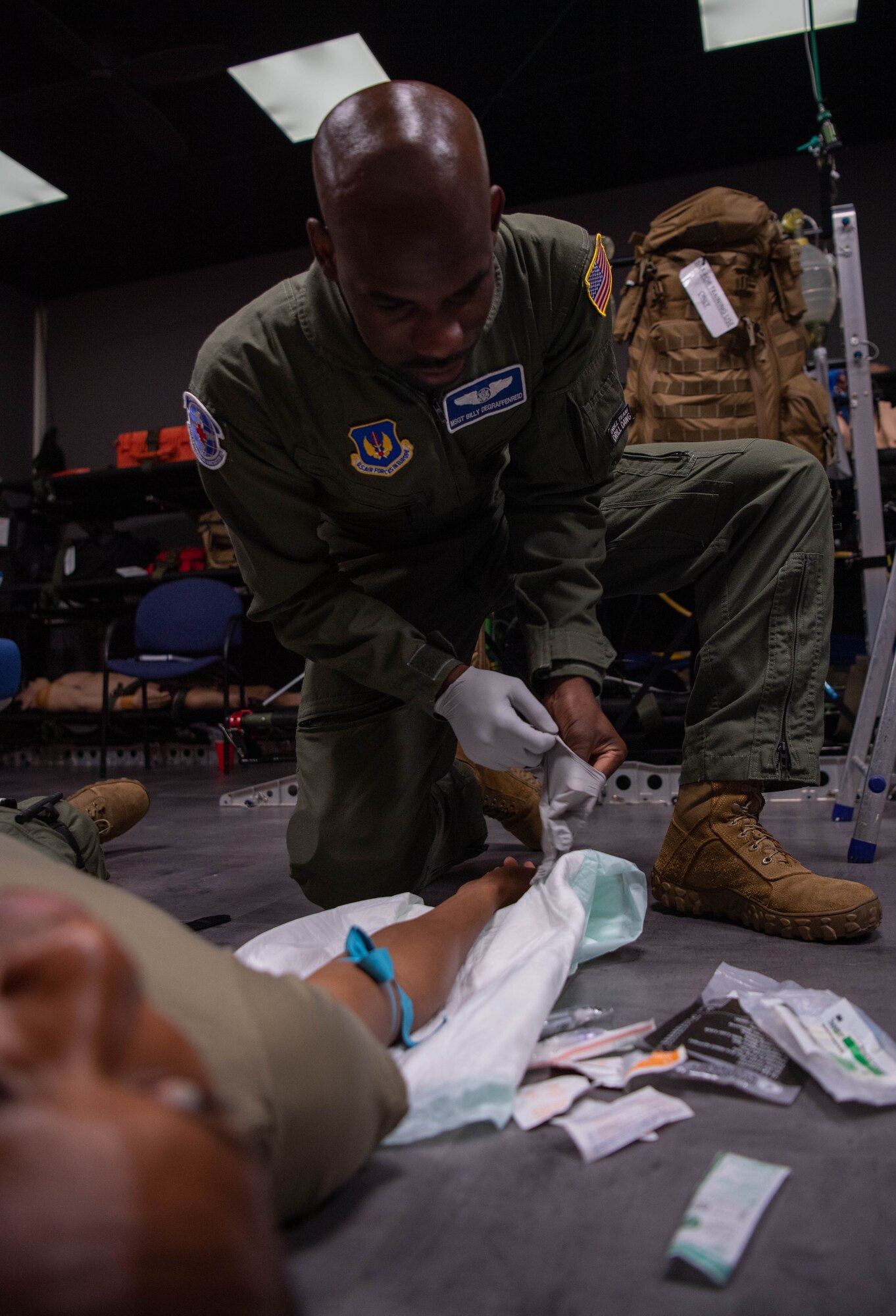 U.S. Air Force Tech. Sgt. Billy Degraffenreid, 86th Aeromedical Evacuation Squadron aeromedical evacuation technician, prepares to treat a volunteer patient during clinical simulator training at Ramstein Air Base, Germany, Aug. 1, 2023.