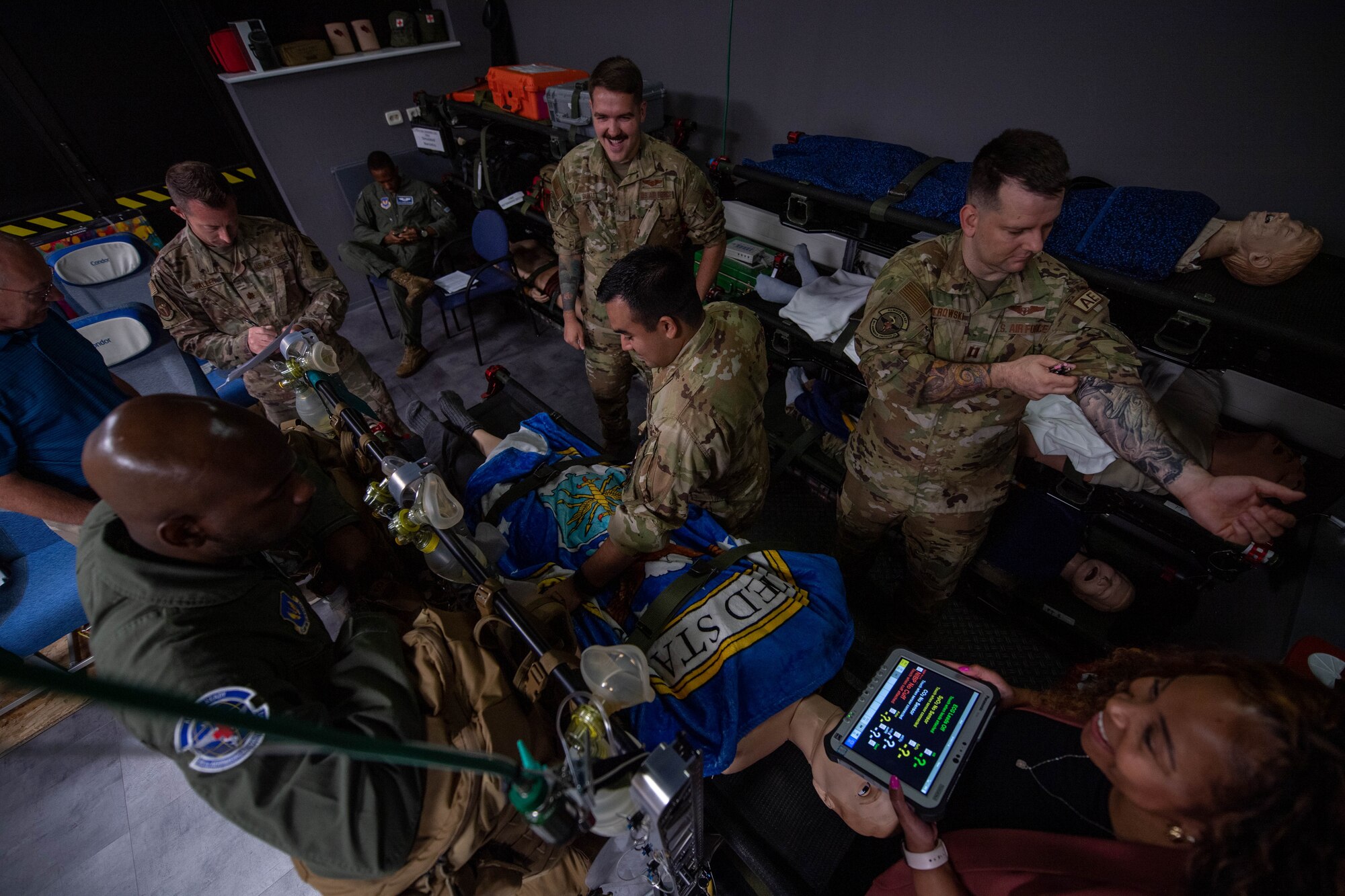 U.S. Air Force aeromedical evacuation technicians and a nurse gather for a pre-brief before clinical simulator training at Ramstein Air Base, Germany, Aug. 1, 2023.