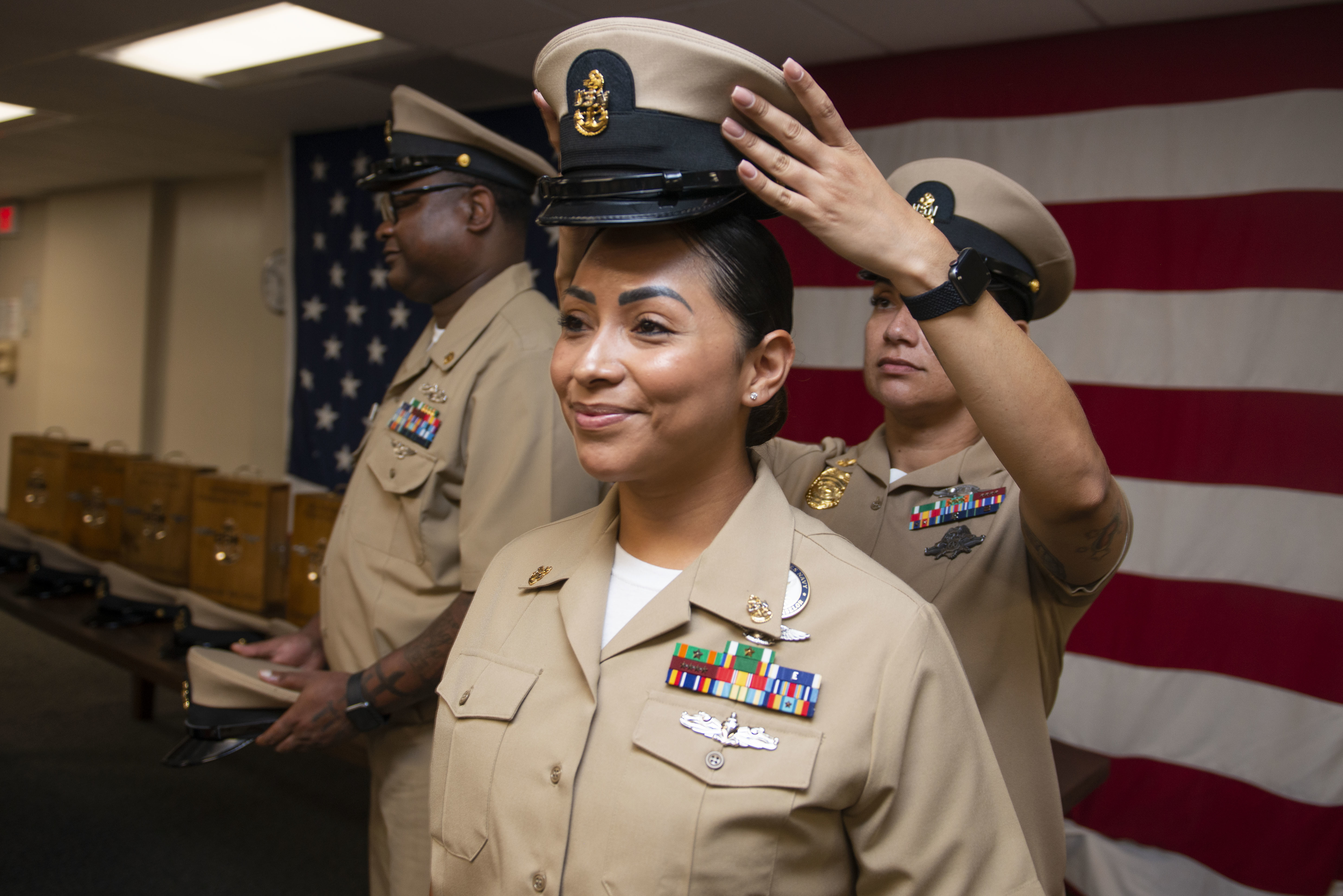 JACKSONVILLE, Fla. (Sept. 29, 2023) – Chief Navy Counselor Alejandrina Alonzo, assigned to Commander, Navy Region Southeast, receives her cover from her sponsor during a Chief Petty Officer pinning ceremony aboard Naval Air Station Jacksonville, Sept. 29, 2023. (U.S. Navy photo by Jacob Sippel/Released)