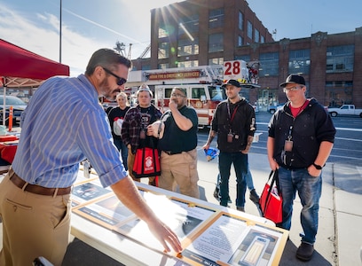 Mike Taylor, fire prevention engineering technician, Code 980M.5, Facility Management and Fire Prevention Program, answers questions for employees Oct. 12, 2022, during a Fire Prevention Week open house. (U.S. Navy photo by Wendy Hallmark)