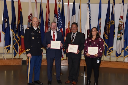 Col. Peter Markot, left, director of the Strategic Initiatives Group at Army Medical Logistics Command, recognizes three individuals for their roles in a National Hispanic Heritage Month observance Sept. 28 at Fort Detrick, Maryland. They include, from left, Dr. Raymond Vazquez, Pedro Bonilla-Vazquez and Cynthia Landin. (C.J. Lovelace)