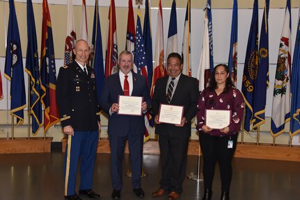 Col. Peter Markot, left, director of the Strategic Initiatives Group at Army Medical Logistics Command, recognizes three individuals for their roles in a National Hispanic Heritage Month observance Sept. 28 at Fort Detrick, Maryland. They include, from left, Dr. Raymond Vazquez, Pedro Bonilla-Vazquez and Cynthia Landin. (C.J. Lovelace)