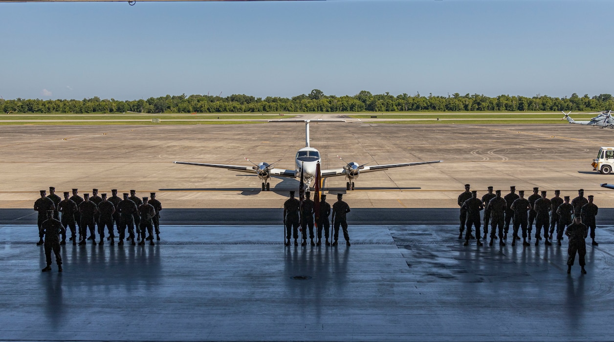 Marines with Marine Transport Squadron (VMR) Belle Chasse stand in formation during a change of command ceremony at a VMR Hangar, Naval Air Station Joint Reserve Base, Belle Chasse, La. on June 2, 2023.