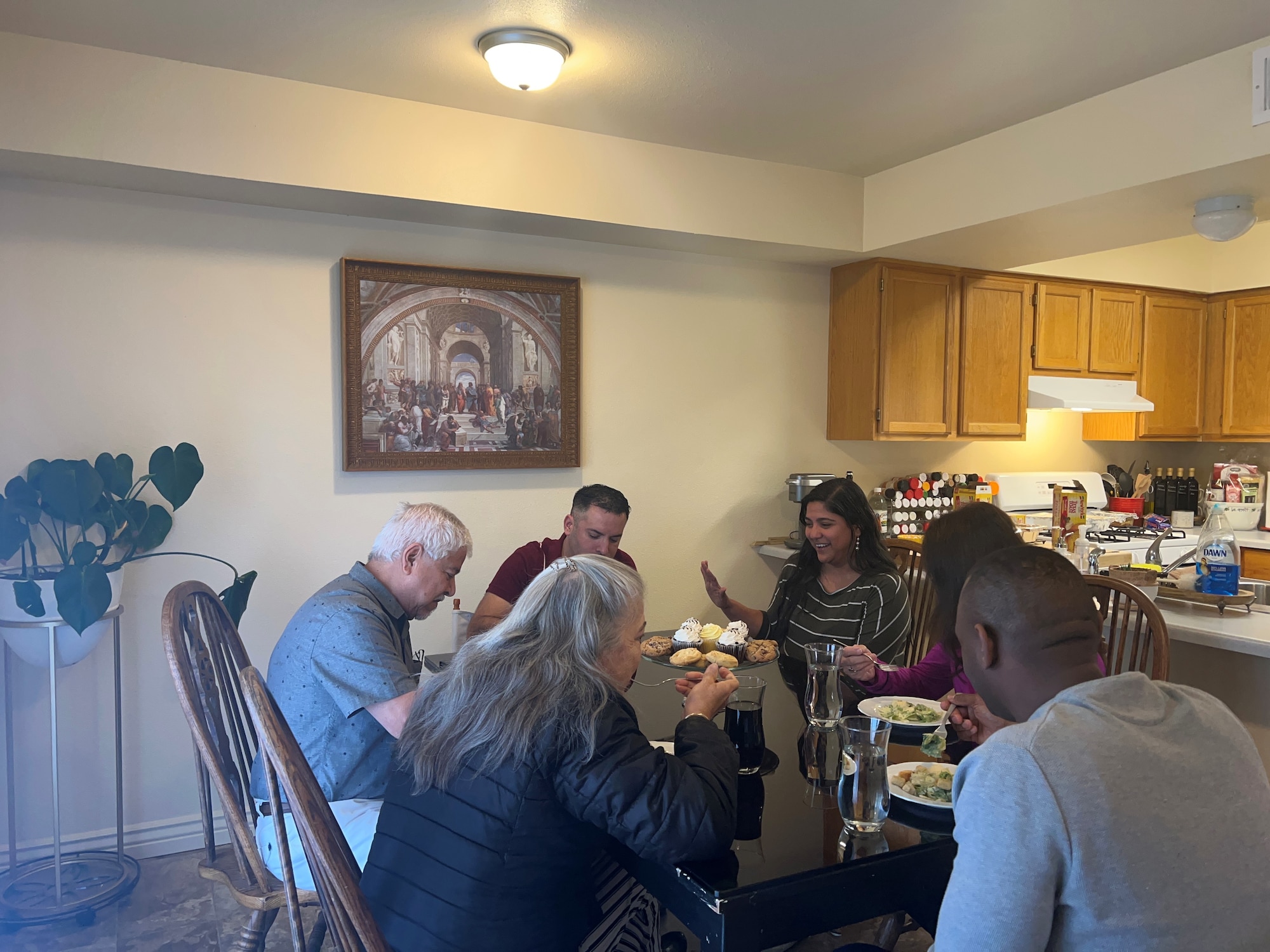 people sharing a meal around a dining table