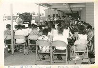 School band at PTA carnival, May 1958. Military housing can be seen in the background, past the armored vehicle.