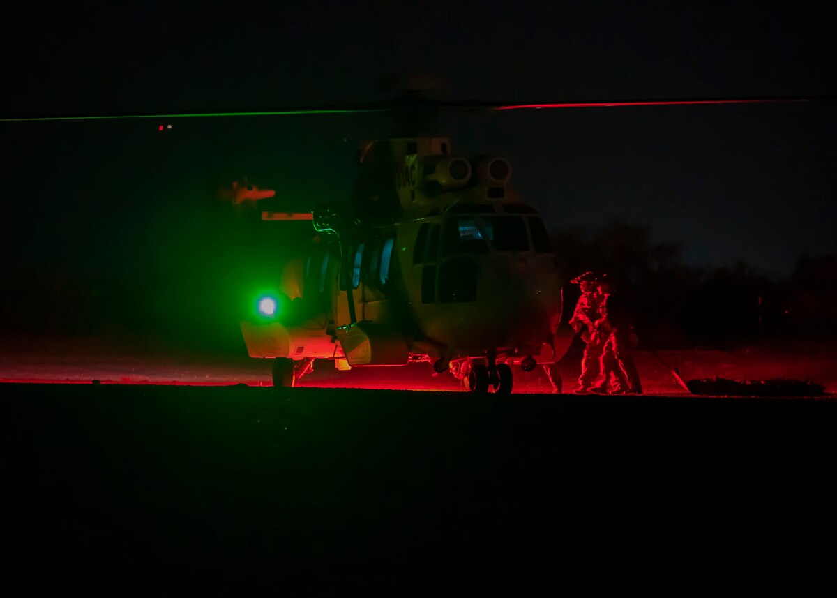 U.S. Airmen, training with the 68th Rescue Squadron, prepare to load a simulated casualty onto an aircraft at Davis-Monthan Air Force Base, Ariz., Aug. 23, 2023. The Airmen rescued the casualty from a simulated mass-casualty event. (U.S. Air Force photo by Airman 1st Class William Finn V)