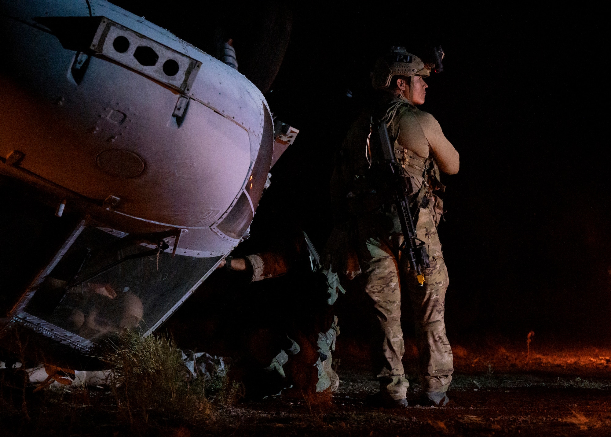U.S. Airmen, training with the 68th Rescue Squadron, search a simulated aircraft crash for casualties at Davis-Monthan Air Force Base, Ariz., Aug. 24, 2023. The Airmen rescued casualties from several simulated crash sites all while engaging with opposing forces during a training scenario. (U.S. Air Force photo by Airman 1st Class William Finn V)