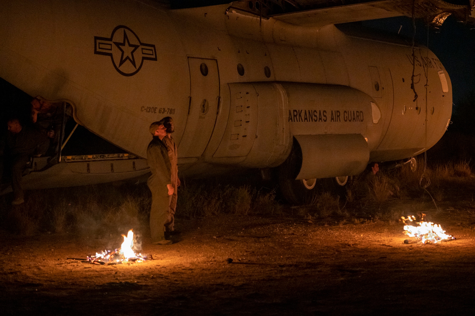 U.S. Airmen, acting as simulated casualties, wait for a 68th Rescue Squadron training exercise to begin at Davis-Monthan Air Force Base, Ariz., Aug. 23, 2023. The exercise simulated a HC-130 Combat King II/Hercules aircraft crash with casualties for the students to locate and rescue. (U.S. Air Force photo by Airman 1st Class Devlin Bishop)