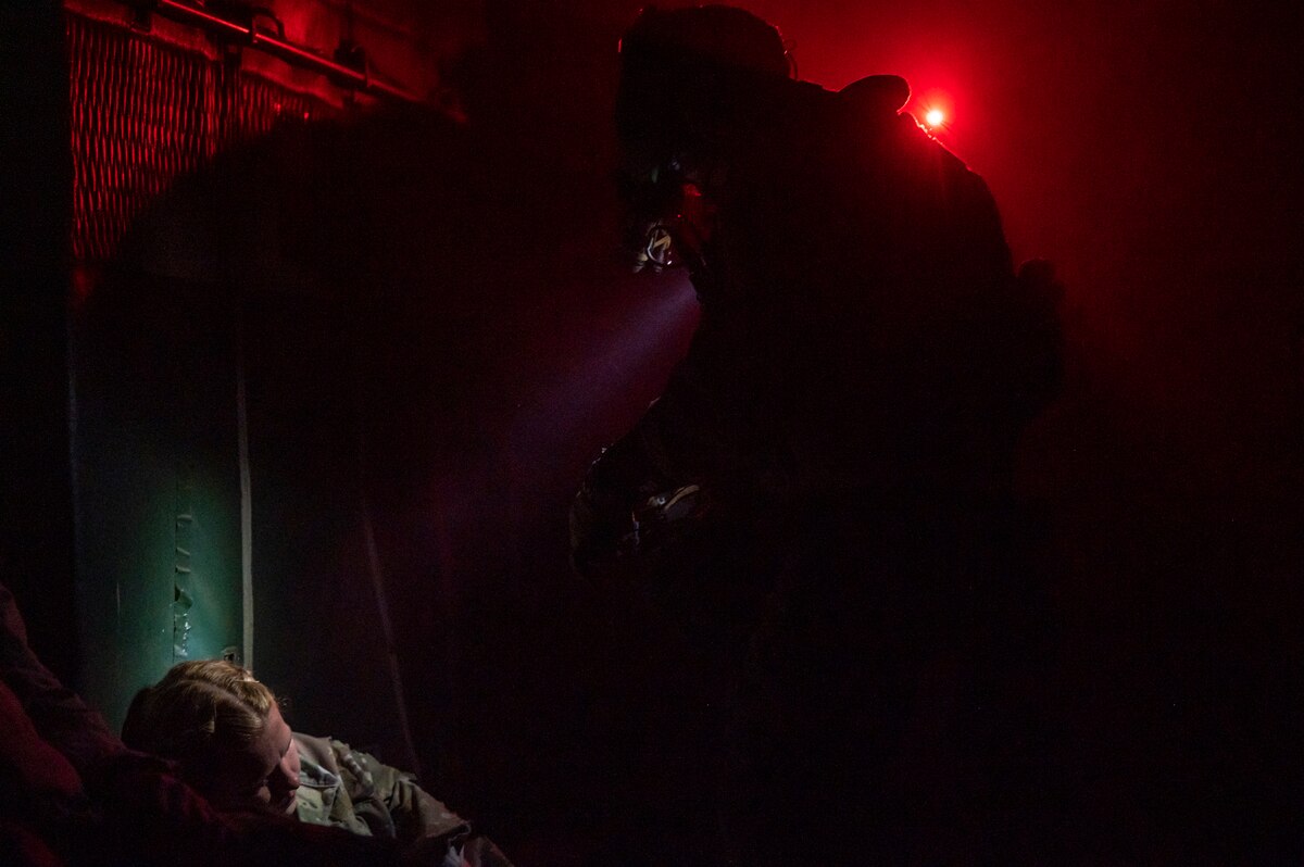 A U.S. Airman, training with the 68th Rescue Squadron, asks a simulated casualty questions about her injuries during the Combat Leader Course at Davis-Monthan Air Force Base, Ariz., Aug. 23, 2023. The exercise focused on enhancing the Airman’s abilities while forcing them to handle multiple casualties simultaneously. (U.S. Air Force photo by Airman 1st Class Devlin Bishop)