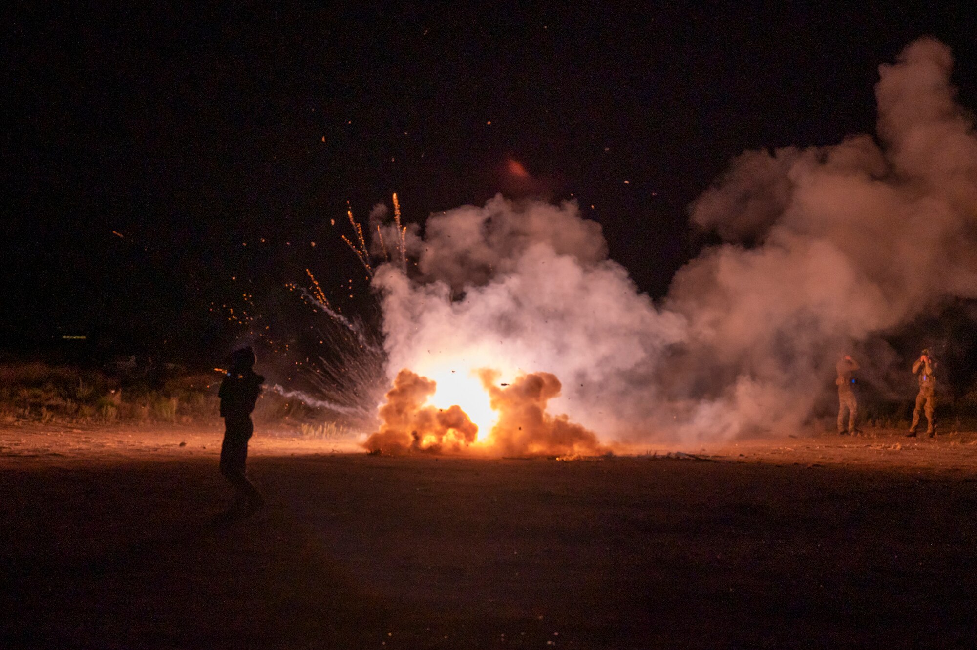 U.S. Airmen, assigned to the 68th Rescue Squadron, detonate simulated artillery during the Combat Leader Course at Davis-Monthan Air Force Base, Ariz., Aug. 23, 2023. The artillery fire provided an added layer of difficulty to the exercise by forcing the training individuals to maintain focus under pressure. (U.S. Air Force photo by Airman 1st Class Devlin Bishop)