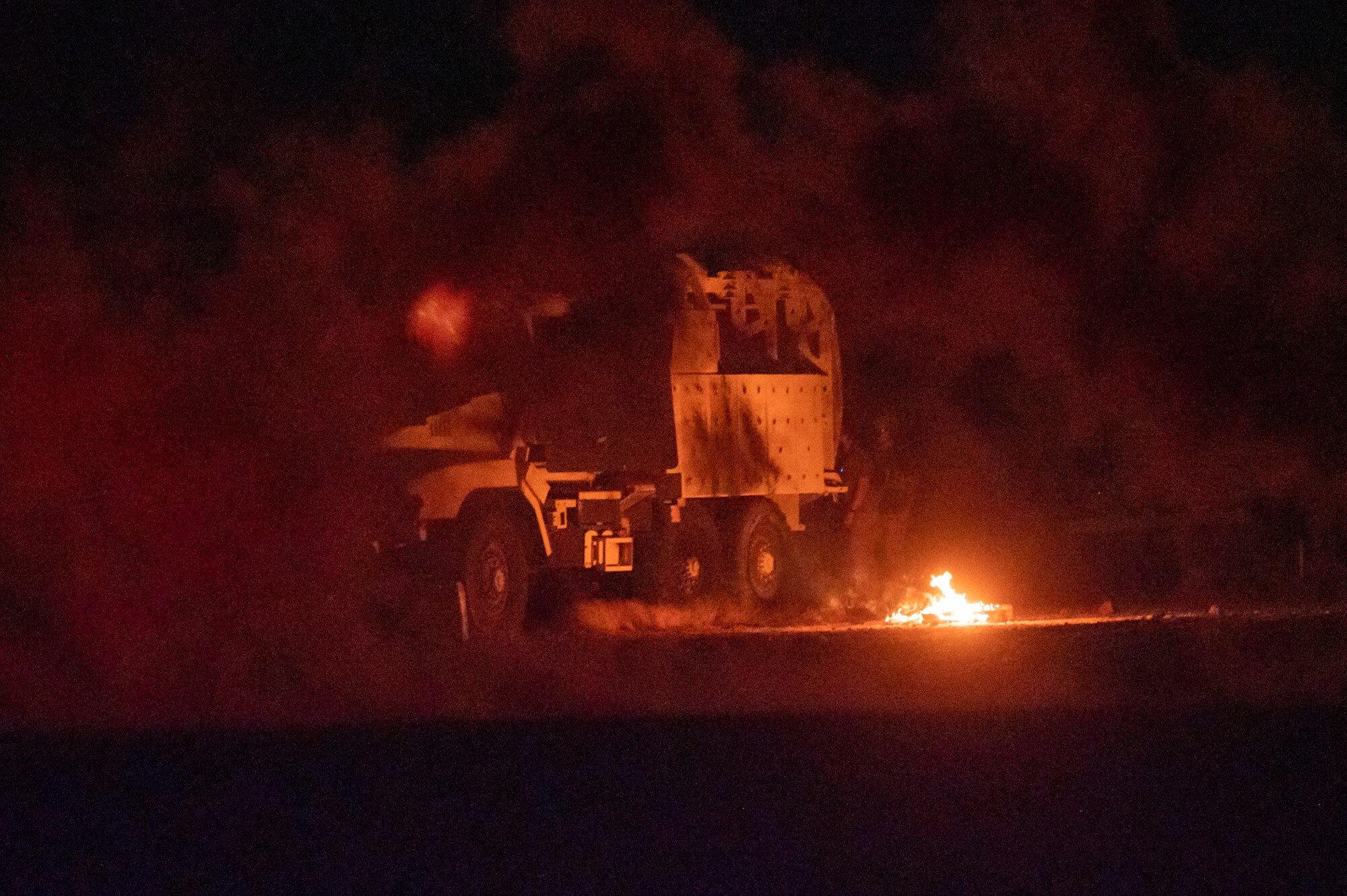 U.S. Airmen, assigned to the 68th Rescue Squadron, observe a Combat Leader Course student as he tends to simulated casualties at Davis-Monthan Air Force Base, Ariz., Aug. 24, 2023. The student used smoke grenades to signal a helicopter to land and receive casualties for exfiltration. (U.S. Air Force photo by Airman 1st Class Devlin Bishop)