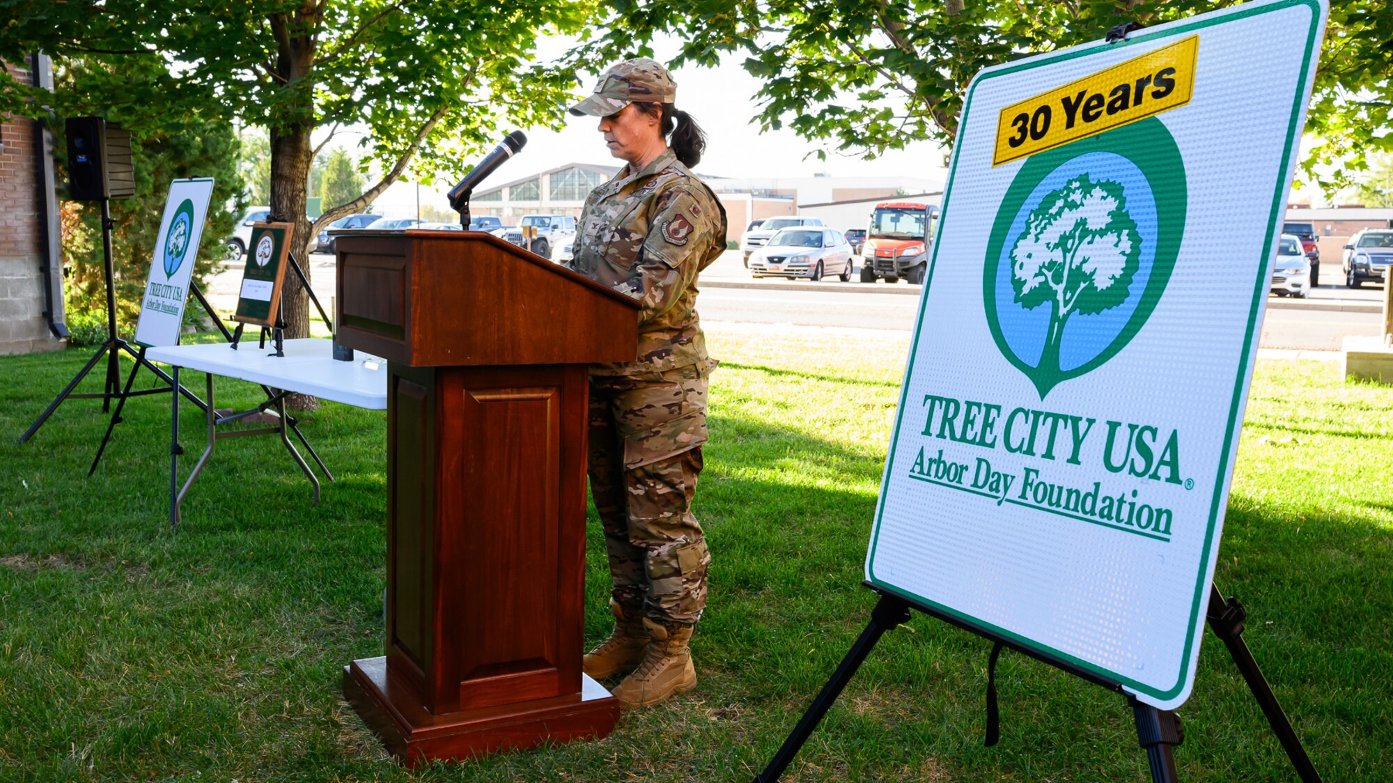 An Air Force commander stands at an outdoor podium