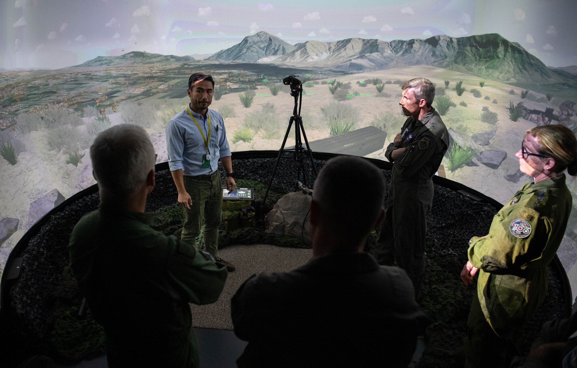 Aaron Corrales, top left, 4th Combat Training Squadron Joint Terminal Attack Controller subject matter expert, briefs NATO Air Chiefs on the capabilities of the JTAC simulator during a tour of the United States Air Forces in Europe, Air Forces Africa Warfare Center (UAWC) at Einsiedlerhof Air Base, Germany, Sept. 27, 2023. The UAWC is the U.S. Air Force's premiere distributed training center in Europe, providing enhanced joint and combined warfighter readiness training through live, virtual and constructive simulation capabilities. (U.S. Air Force photo by Senior Airman Jared Lovett)