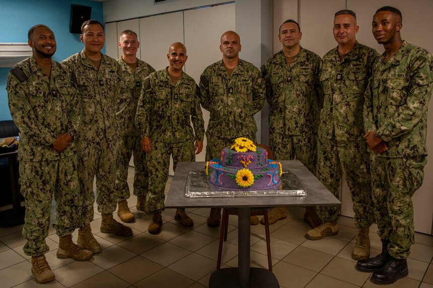 Sailors assigned to Naval Support Activity Souda Bay cut a ceremonial cake during a National Hispanic Heritage Month Celebration held by the Souda Bay Multicultural Committee in The Anchor on Sept. 28, 2023. NSA Souda Bay is an operational ashore installation which enables and supports U.S., Allied, Coalition, and Partner nation forces to preserve security and stability in the European, African, and Central Command areas of responsibility.