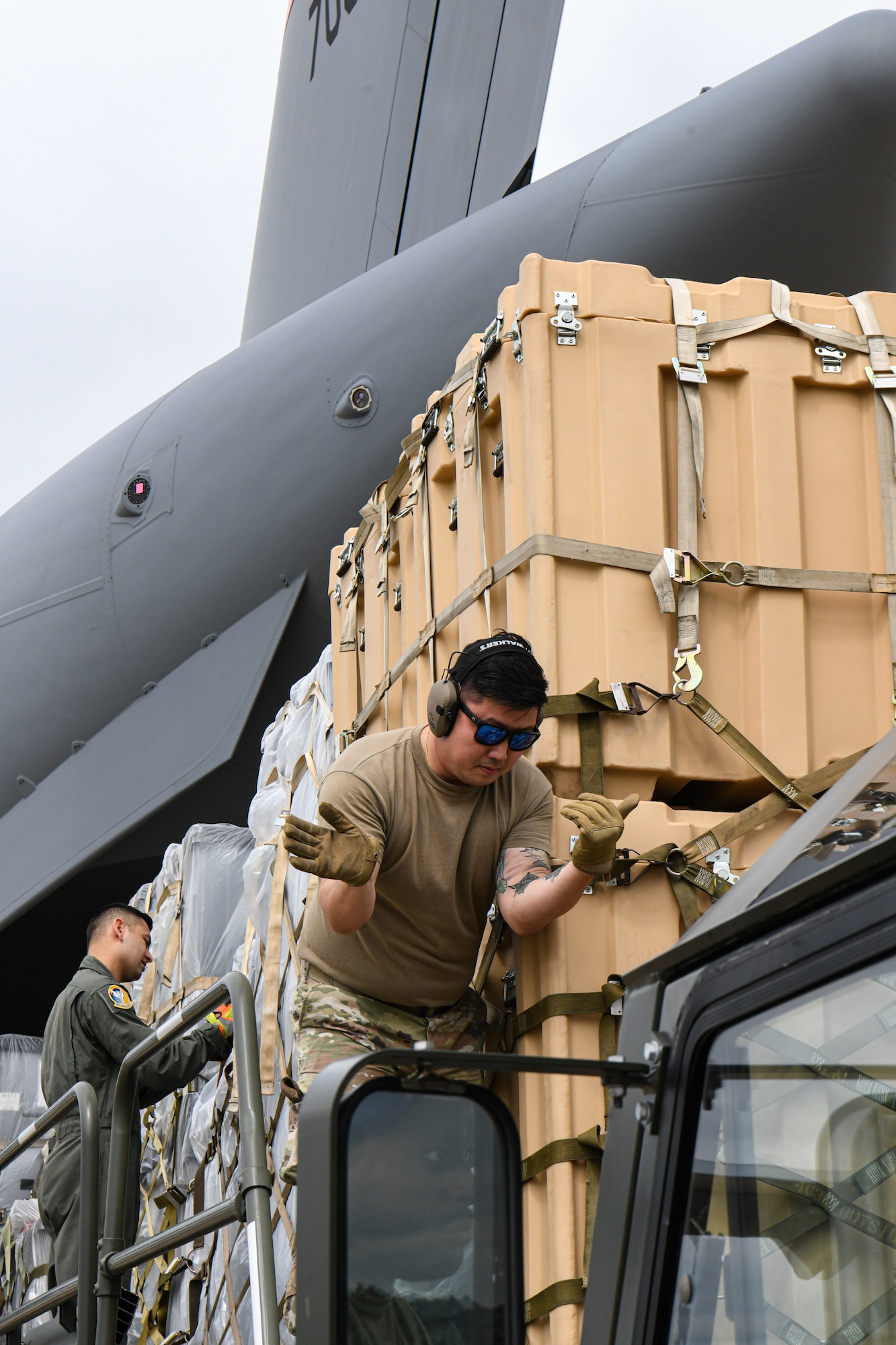 Members of Youngstown Air Reserve Station's 76th Aerial Port Squadron and March Air Reserve Base's 452nd Air Mobility Wing load cargo onto a 452nd AMW C-17 Globemaster III at YARS, Ohio, Sept. 9, 2023.