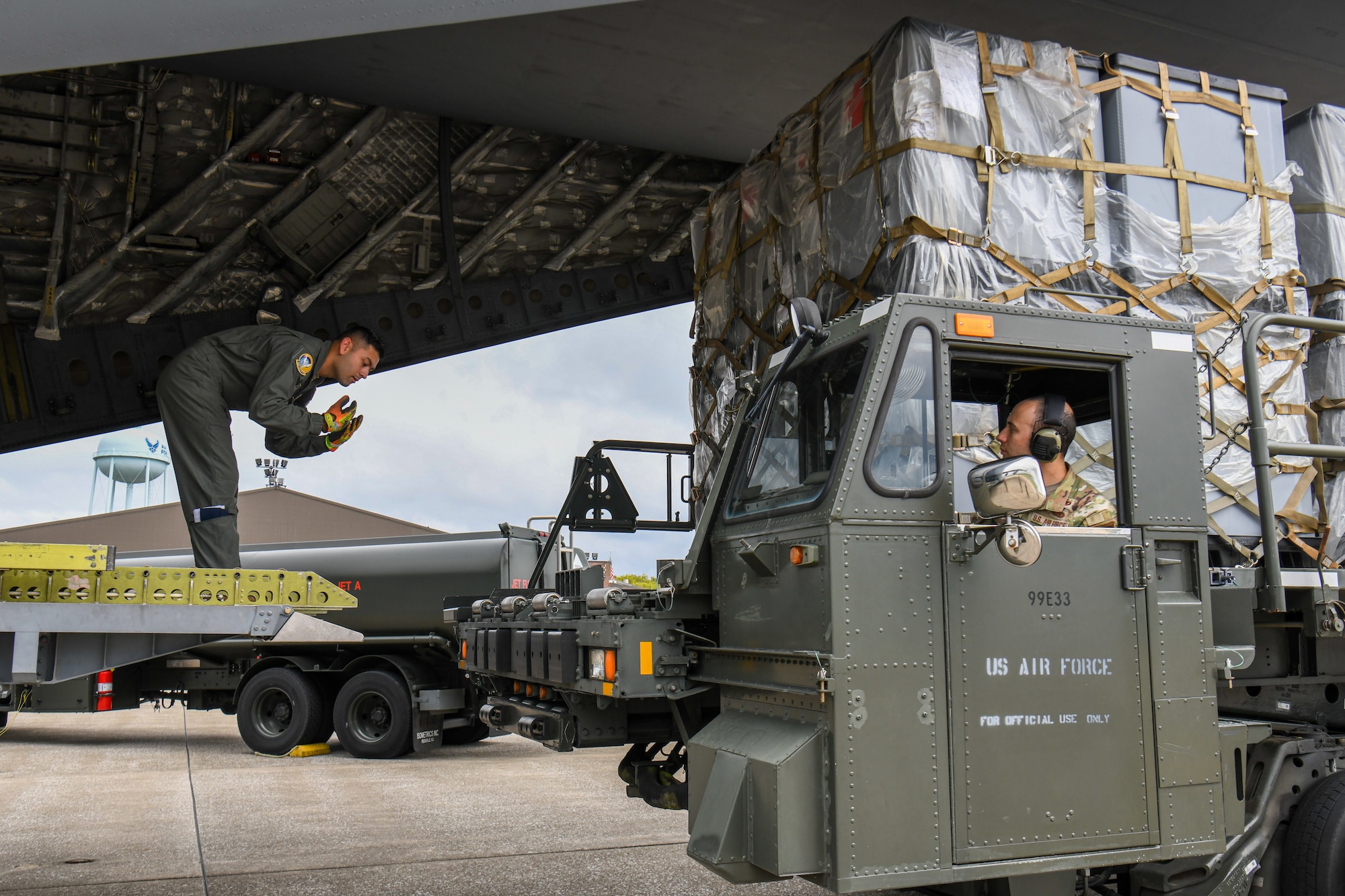 Members of Youngstown Air Reserve Station's 76th Aerial Port Squadron and March Air Reserve Base's 452nd Air Mobility Wing load cargo onto a 452nd AMW C-17 Globemaster III at YARS, Ohio, Sept. 9, 2023.