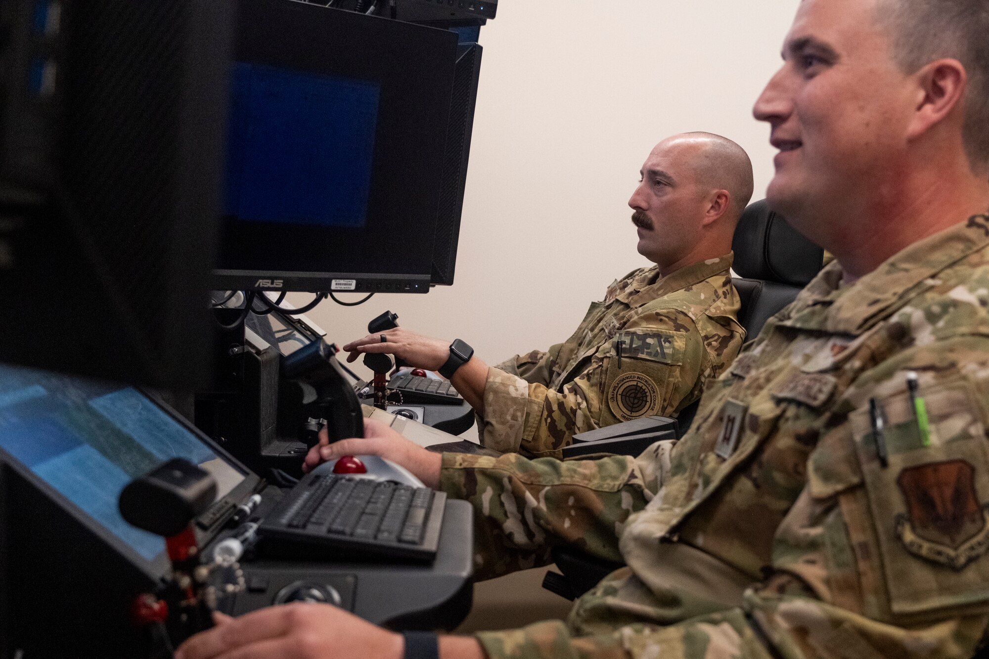 Two United States Air Force MQ-9 Reaper remotely piloted aircraft operators from the 103rd Observation Squadron, 11th Attack Wing, Pennsylvania Air National Guard, fly a simulated mission during exercise Reaper Smoke 2023 at Hancock Field Air National Guard Base in Syracuse, NY, Sep. 21. During the event more than 45 MQ-9 Reaper crews from across all three components of the U.S. Air Force put their skills to the test to see who among them was the “best of the best.” (U.S. Air National Guard photo by Alexander Rector)